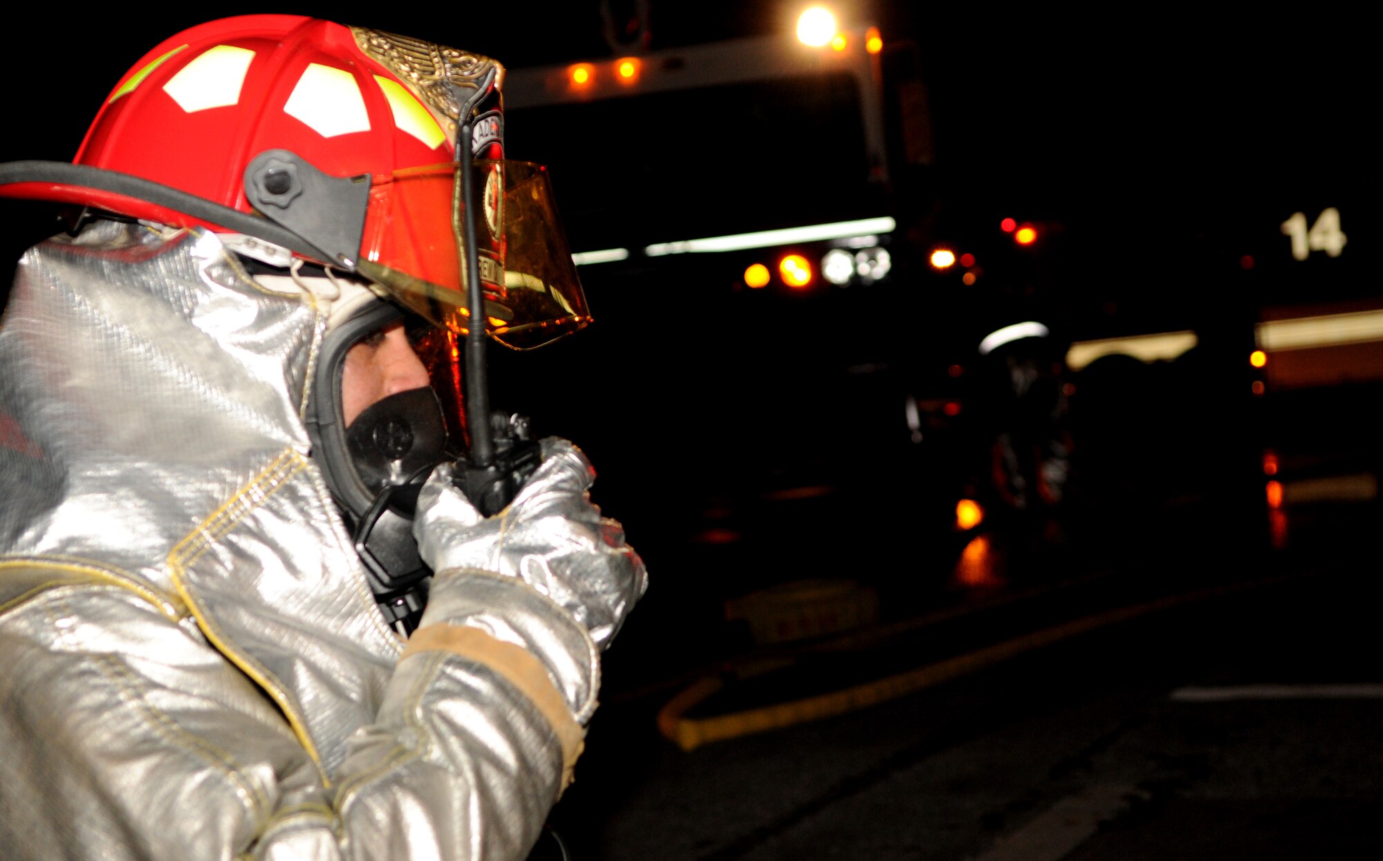 A fireman from the 18th Civil Engineer Squadron radios information about a simulated burning building to his command during Beverly High 11-02, a local operational readiness exercise at Kadena Air Base, Japan, Jan. 20. This simulation tested the fire department’s ability to respond to an emergency situation. (U.S. Air Force photo/Airman 1st Class Jarvie Z. Wallace)