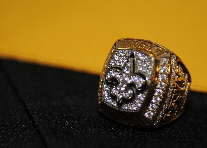 Former New Orleans Saints wide receiver, Michael K. Lewis, showcases his 2010 Super Bowl ring to football fans at Barksdale Base Exchange, Jan. 19. Airmen, dependents and retirees had an once-in-a-lifetime opportunity to receive autographs, hold the Lombardi trophy, take photos and even wear Mr. Lewis?s Super Bowl ring. The 14-karat, yellow-gold ring symbolizes their miracle season. There are 60 diamonds on the ring, totaling 2.20 karats. (U.S. Air Force photo/Senior Airman Alexandra M. Boutte) (RELEASED)