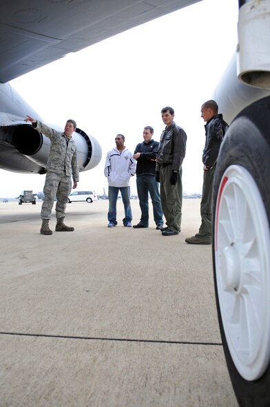 Michael Lewis (left center) receives a briefing from Senior Airman Michael Miller, 96th Bomb Squadron crew chief, during a B-52H Stratofortress static display Jan. 19 at Barksdale Air Force Base, La. Mr. Lewis, a former New Orleans Saints? player and ambassador, came to Barksdale to sign autographs and to meet Airmen. Many got the opportunity to take pictures with him and the Saints' 2010 Lombardi Super Bowl Trophy. (U.S. Air Force photo/Staff Sgt. John Gordinier)