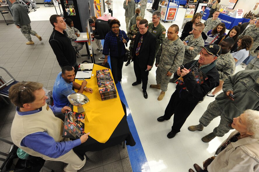 A crowd lines up for autographs and pictures with former New Orleans Saints football player, Michael Lewis at the Base Exchange, Jan. 19 at Barksdale Air Force Base, La. Mr. Lewis and Austin Bull brought the New Orleans's Saints? 2010 Lombardi Super Bowl Trophy with them. For more than two hours, Airmen, dependents, retirees and civilians took pictures holding the trophy and some even received the opportunity to wear Mr. Lewis' Super Bowl ring. (U.S. Air Force photo/Staff Sgt. John Gordinier)