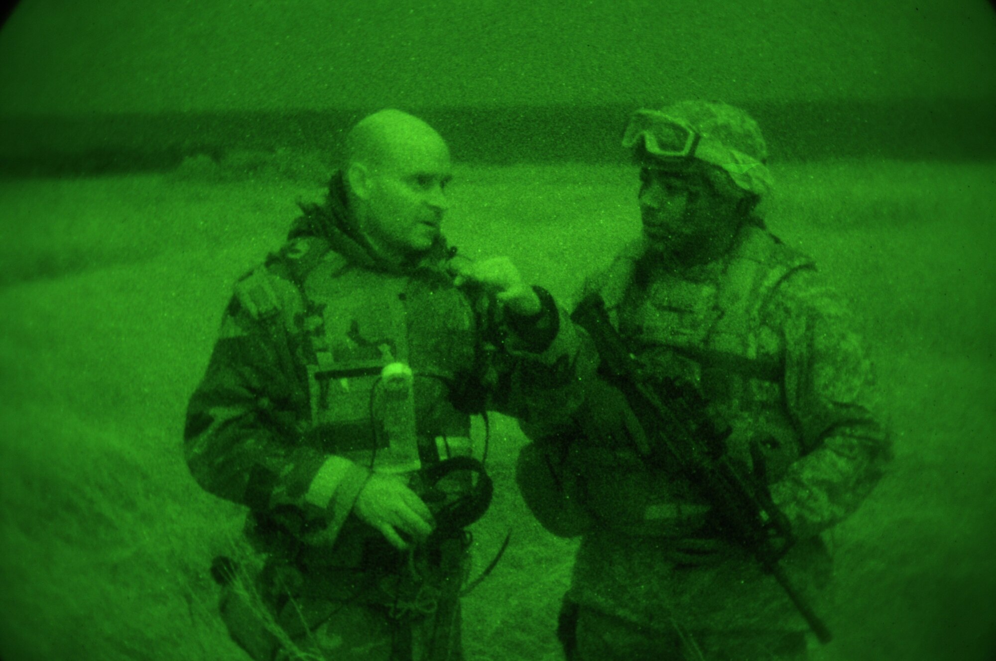 IE SHIMA AIRFIELD, Japan ? Maj. (Dr.) John Hatfield, a flight surgeon with the 353rd Special Operations Support Squadron, discusses the medical team's status with Staff Sgt. Julian Taylor, a fly-away security team leader with the 353rd SOSS, during an exercise to test the Security Forces Flight's ability to provide fly-away security for an aircraft and medical personnel at an airfield in "hostile" territory here Jan. 19 as part of Beverly High 11-02, a local operational readiness exercise. The scenario was the first time the Security Forces Flight tested their fly-away security capabilities during a local readiness exercise. Members of the 353rd Special Operations Group are participating in the exercise to hone their warfighting skills in preparation for a headquarters inspection next month. (U.S. Air Force photo by Tech. Sgt. Aaron Cram)