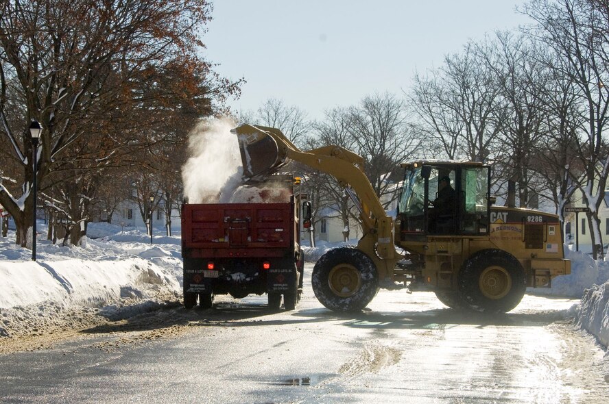 HANSCOM AIR FORCE BASE, Mass. – Snow is dumped into a dump truck in the housing area on Jan. 13. The base closed for two days after more than a foot of snow fell on Jan. 12. This was the second major snowstorm of the season. (U.S. Air Force photo by Mark Herlihy)