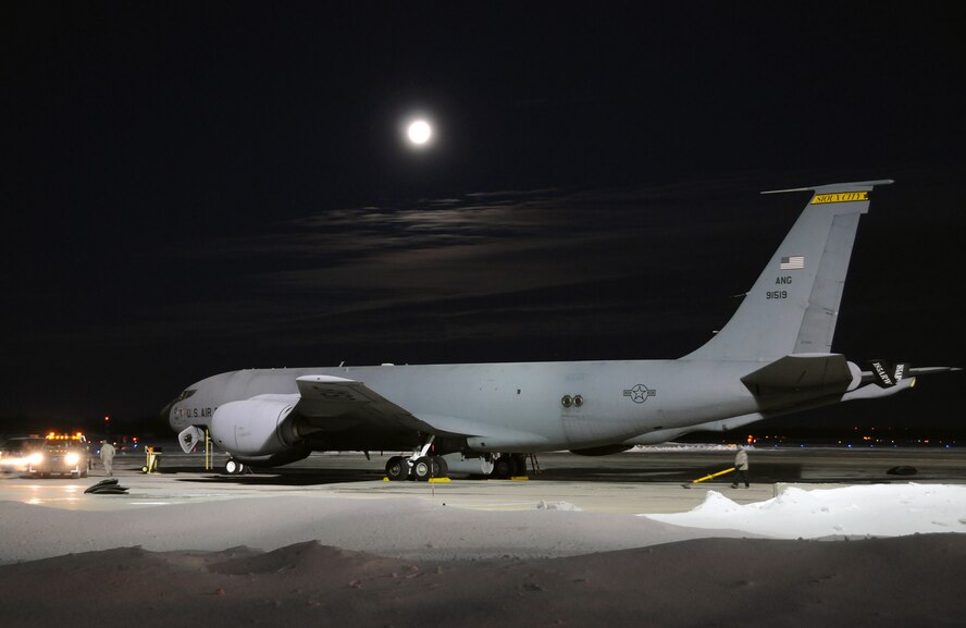 A full moon serves as a picturesque back drop on a bitterly cold January morning.  With temperatures in the single digits crew members from the 185th Air Refueling Wing (ARW) prepare a KC-135 for a day of flying. The aircraft is on the ramp at the Iowa National Guard’s 185th Air Refueling Wing in Sioux City, Iowa. USAF Photo: MSgt Vincent De Groot 185ARW PA