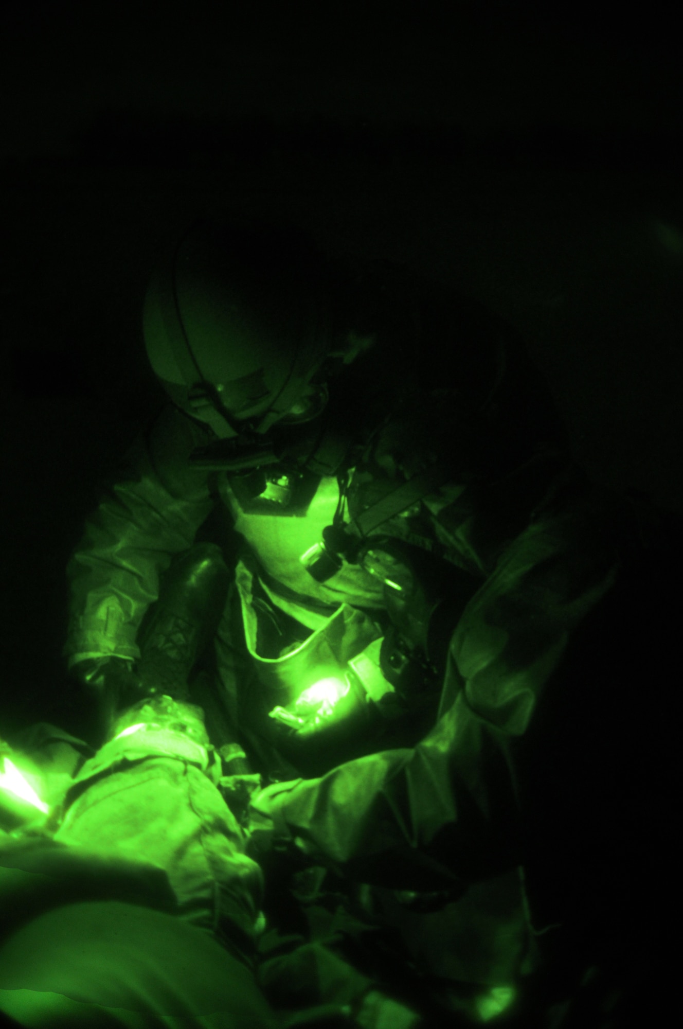 IE SHIMA AIRFIELD, Japan -- Staff Sgt. Nick Johnson, a medical logistics specialist with 353rd Special Operations Support Squadron, treats a broken leg on a "contaminated" patient during an exercise treating and decontaminating patients at an airfield in "hostile" territory here Jan. 19 as part of Beverly High 11-02, a local operational readiness exercise. Members of the 353rd Special Operations Group are participating in the exercise to hone their warfighting skills in preparation for a headquarters inspection next month. (U.S. Air Force photo by Tech. Sgt. Aaron Cram)