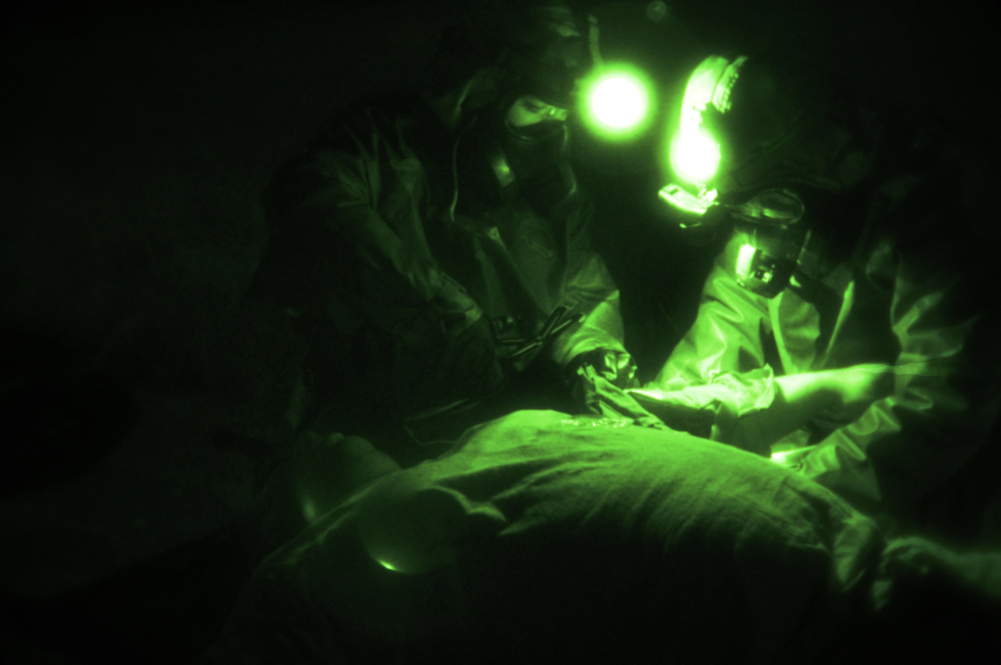 IE SHIMA AIRFIELD, Japan -- Medics with the 353rd Special Operations Support Squadron remove "contaminated" gear from a casualty during an exercise treating and decontaminating patients at an airfield in "hostile" territory here Jan. 19 as part of Beverly High 11-02, a local operational readiness exercise. Members of the 353rd Special Operations Group are participating in the exercise to hone their warfighting skills in preparation for a headquarters inspection next month. (U.S. Air Force photo by Tech. Sgt. Aaron Cram)