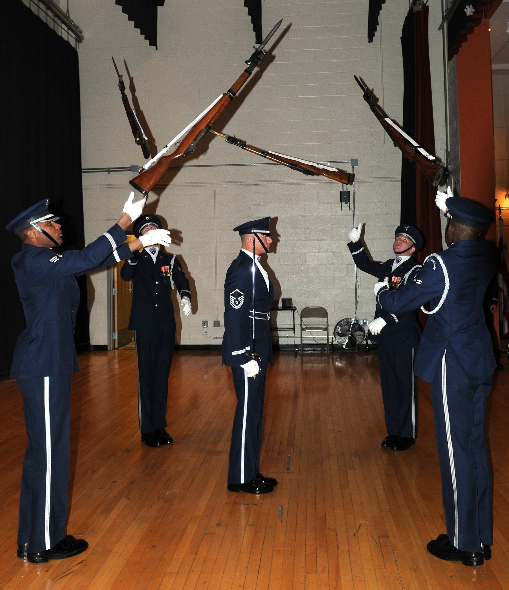 AIR FORCE DISTRICT OF WASHINGTON -- The U.S. Air Force Honor Guard drill team tosses their weapons Jan. 17 at the Martin Luther King Jr. Day of Service performance at John Philip Sousa Middle School, Washington, D.C. The USAF Honor Guard performs in the local community to raise awareness of the Air Force mission. (U.S. Air Force photo by Senior Airman Christopher Ruano)