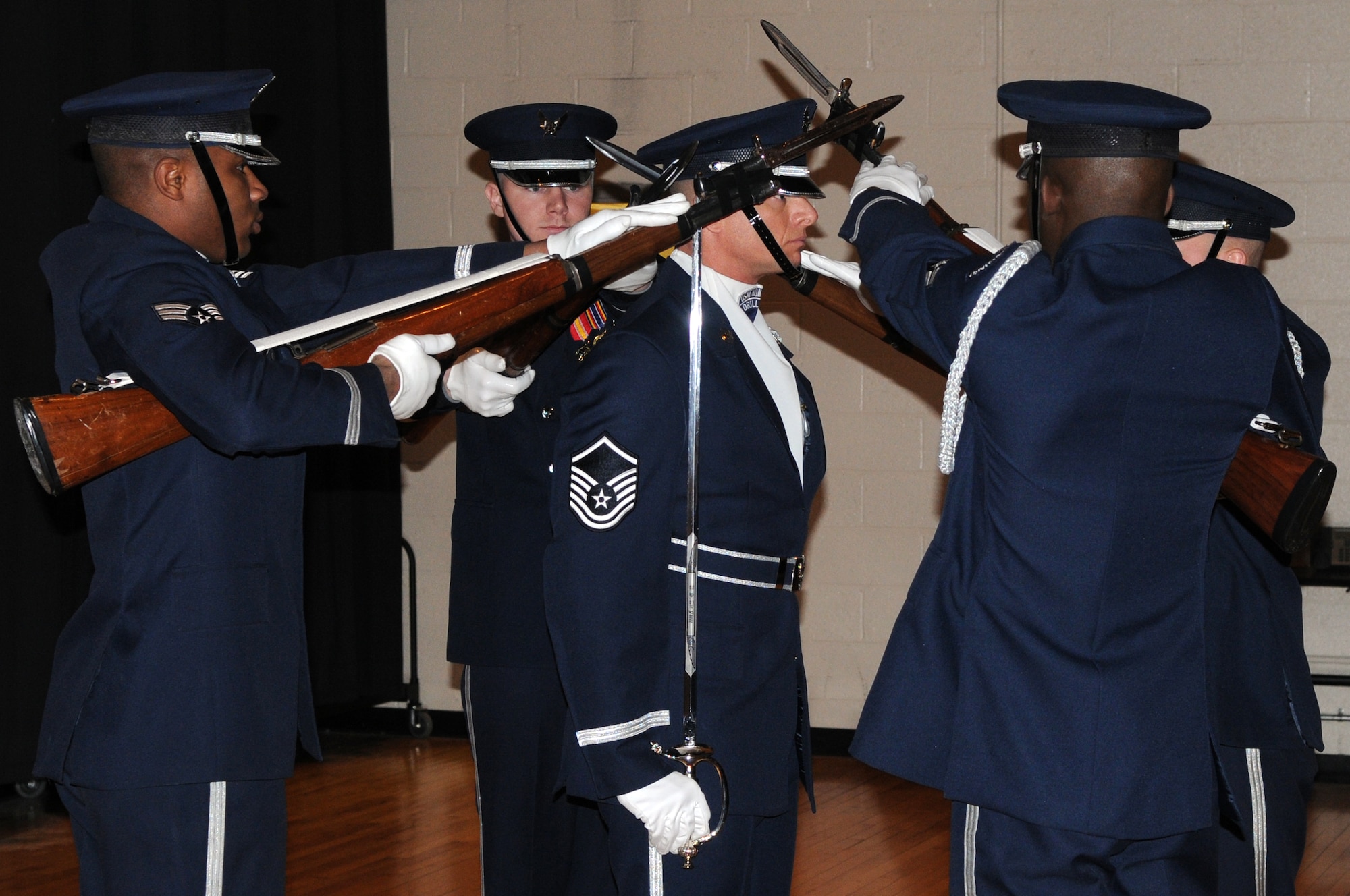 AIR FORCE DISTRICT OF WASHINGTON --The U.S. Air Force Honor Guard drill team thrust their bayonets toward Master Sgt. Nathan Todd, U.S. Air Force Honor Guard drill team flight chief, Jan. 17 at the Martin Luther King Jr. Day of Service performance at John Philip Sousa Middle School, Washington, D.C. The USAF Honor Guard performs precise movements to showcase the Air Force core values and dedication. (U.S. Air Force photo by Senior Airman Christopher Ruano) 