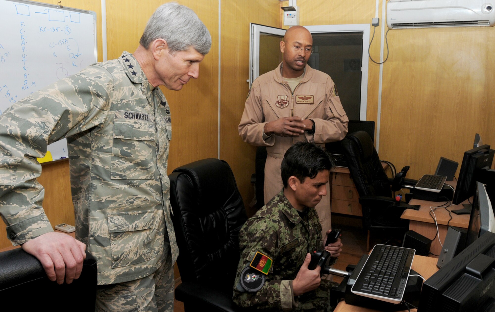 Air Force Chief of Staff Gen. Norton Schwartz observes Afghan air force Lt. Jamshid Baryalai demonstrate a simulated flight during his visit to the English immersion lab known as "Thunder Lab" Jan.18, 2011, in Kabul, Afghanistan. (U.S. Navy photo/Petty Officer 3rd Class Jared E. Walker)
