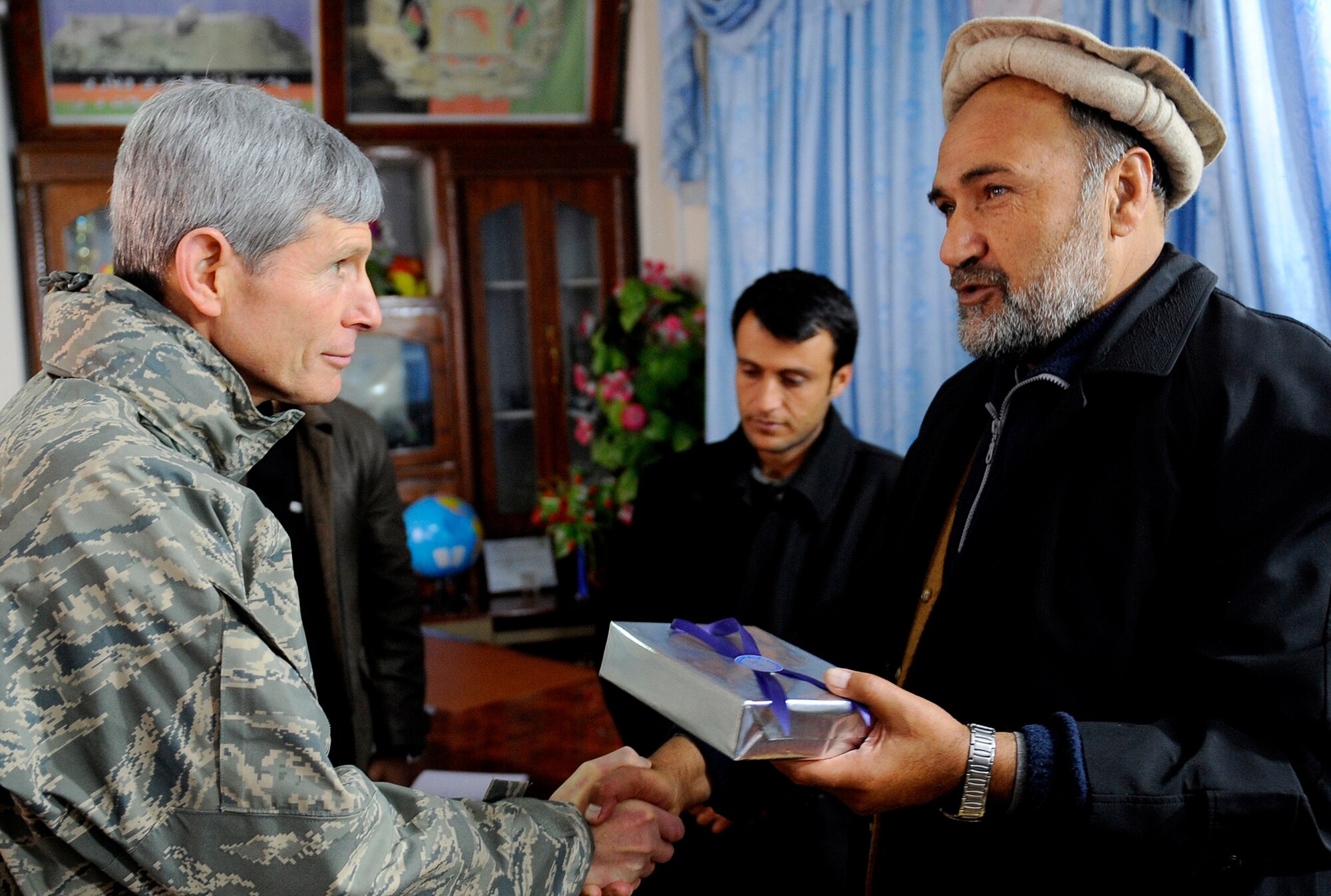 Air Force Chief of Staff Gen. Norton Schwartz presents a gift to Ashraf Naseri, the Zabul Provincial governor, during a visit Jan. 20, 2011, to Forward Operating Base Smart, Afghanistan. The visit was part of the general's trip to the U.S. Central Command area of responsibility. (U.S. Air Force photo/Staff Sgt. Brian Ferguson)