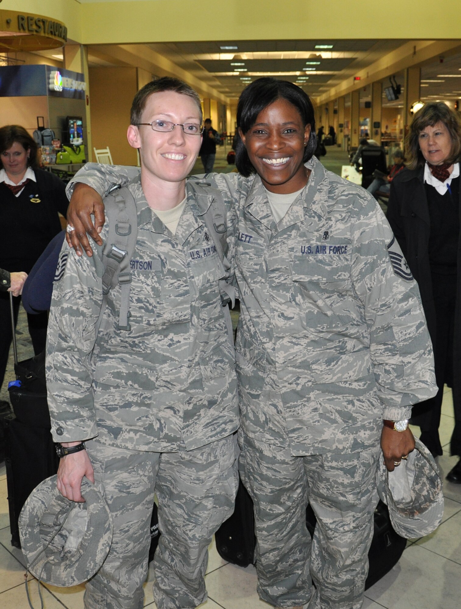 WRIGHT-PATTERSON AIR FORCE BASE, Ohio – Master Sgt. Chirron Hayslett, 445th Aeromedical Staging Squadron (right), poses for a photo with Tech. Sgt. Angela Robertson, 445th Aeromedical Staging Squadron, at the Dayton International Airport Jan. 5. Sergeant Robertson just returned from a 179-day deployment to Joint Base Balad, Iraq. (U.S. Air Force photo/Senior Airman Mikhail Berlin)