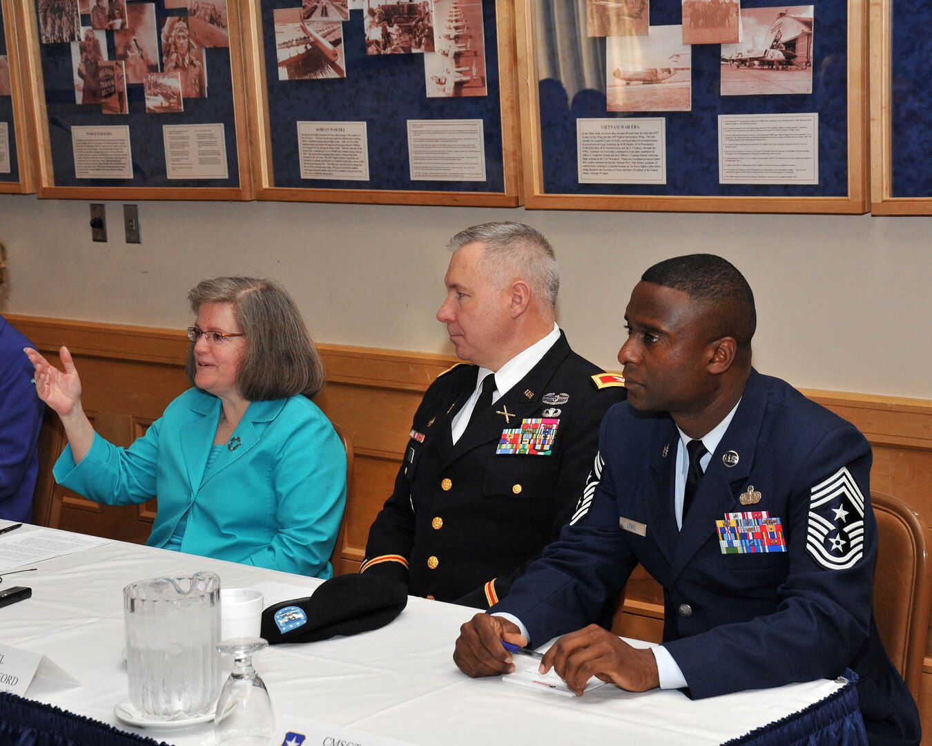 Holly Petraeus, team lead of the Office of Servicemember Affairs for the Consumer Financial Protection Bureau implementation team, responds to a question from a Joint Base San Antonio service member during a Jan. 18, 2011, meeting at Lackland Air Force Base, Texas, to discuss the unique financial issues facing military families. She is joined on the panel by Army Col. Robert S. Bridgford, 502nd Air Base Wing vice commander, and Chief Master Sgt. Juan Lewis, 502nd ABW command chief. (U.S. Air Force photo/Alan Boedeker)