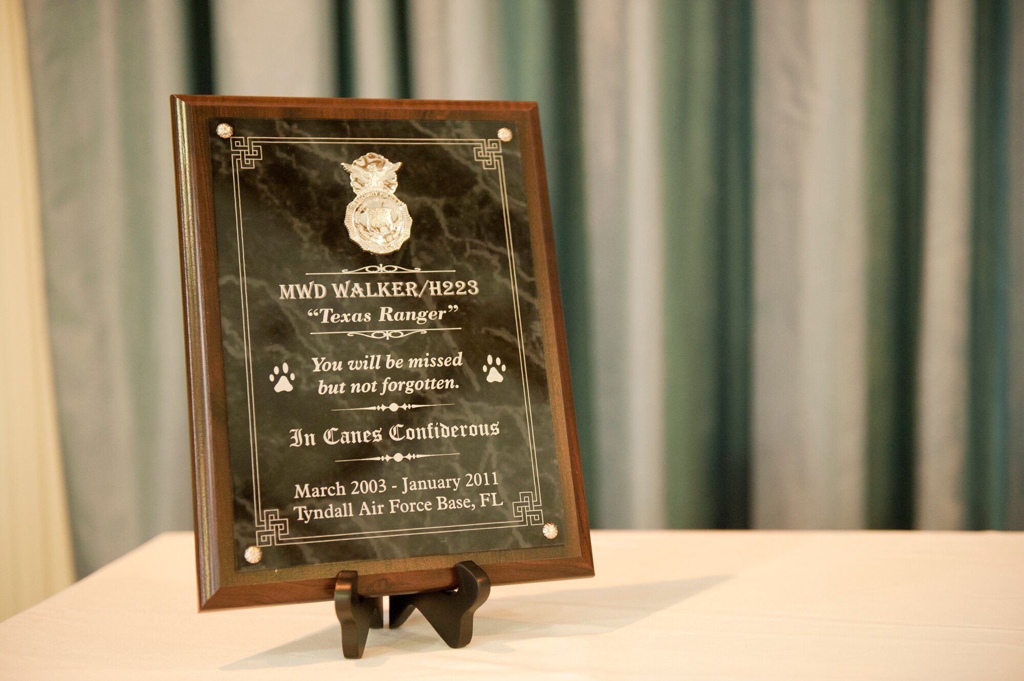 A plaque memorializing the military working dog Walker is displayed during a memorial service honoring his life and military service Jan. 18. (U.S. Air Force photo by Jonathan Gibson)