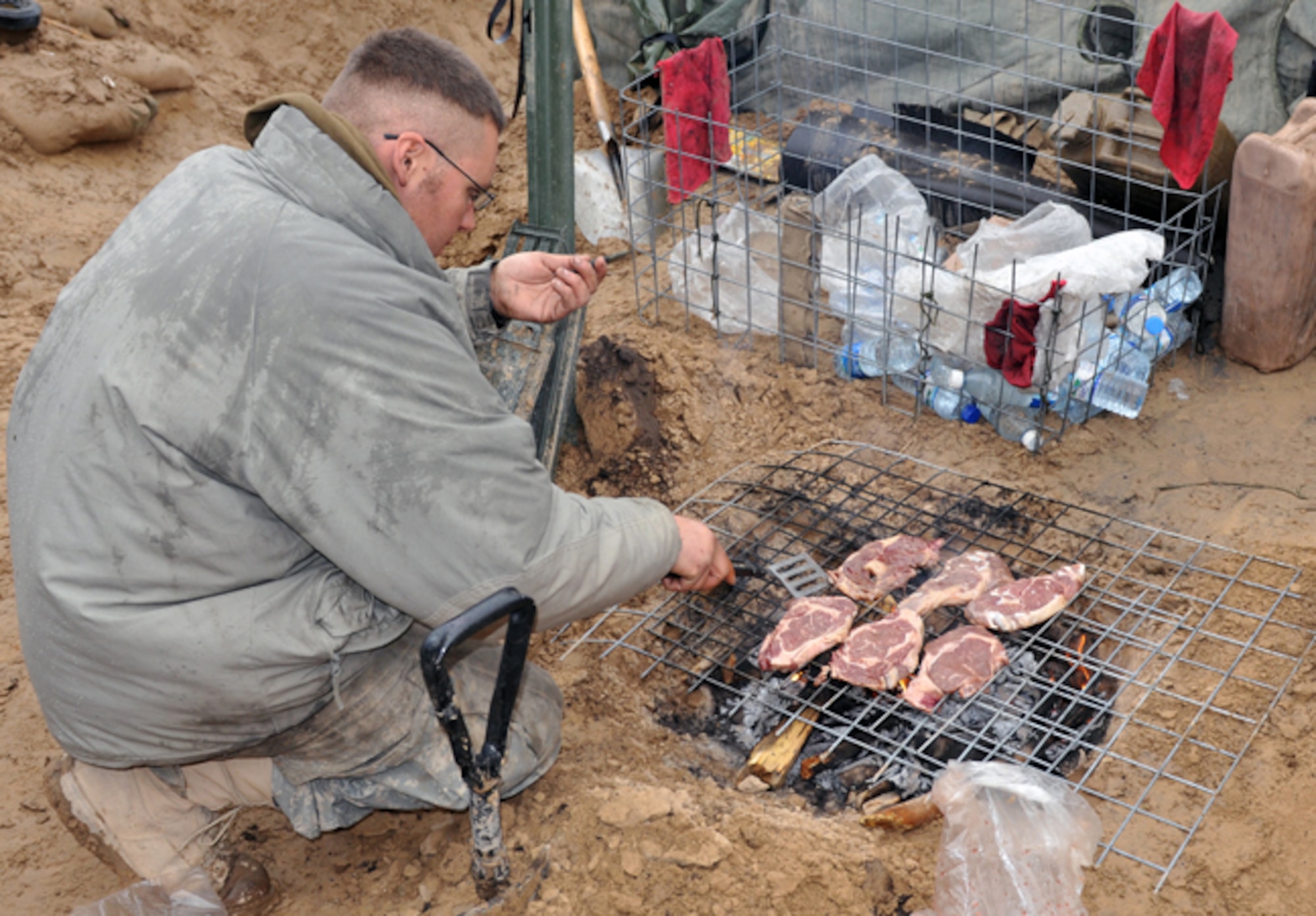 BADGHIS, Afghanistan -- Army Sgt. Nathan Gates, a scout with the 7th Squadron, 10th Cavalry Regiment, 1st Brigade, 4th Infantry Division, at Fort Carson, Colo., cooks breakfast for his Soldiers at Observation Post Cougar, Badghis Province, Afghanistan, Jan. 18, 2011. Sergeant Gates hails from Gouverneur, N.Y. (U.S. Air Force photo/Tech. Sgt. Kevin Wallace)
