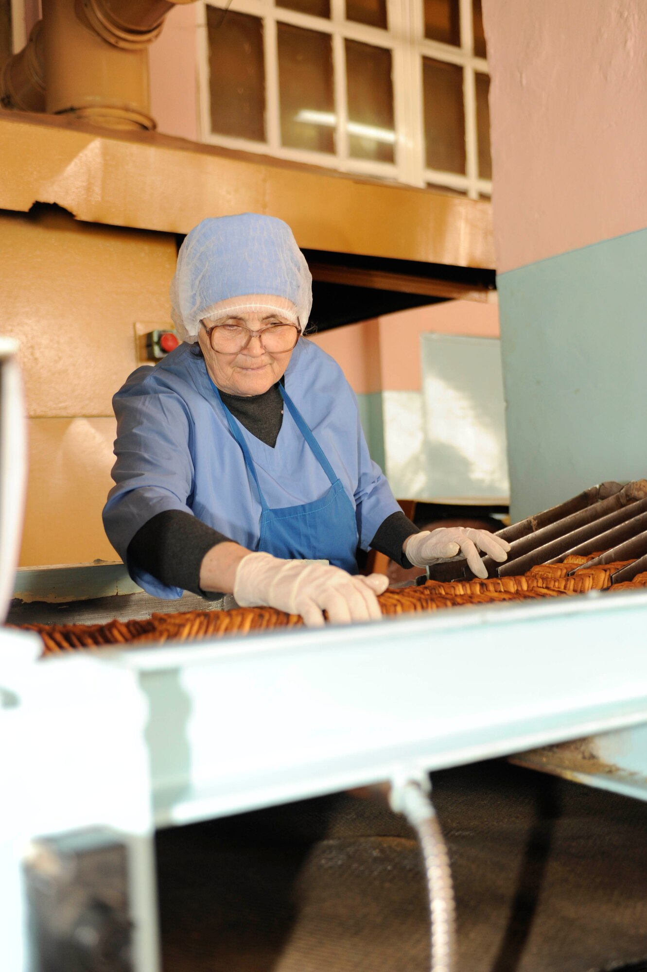 BISHKEK, Kyrgyzstan -- Baked cookies work their way through the quality control station at the Tattoo Bakery.  Transit Center at Manas officials are looking at expanding the dining facility menu to include locally manufactured goods.  (U.S. Air Force photo/Tech. Sgt. Jerome C. Baysmore) 
