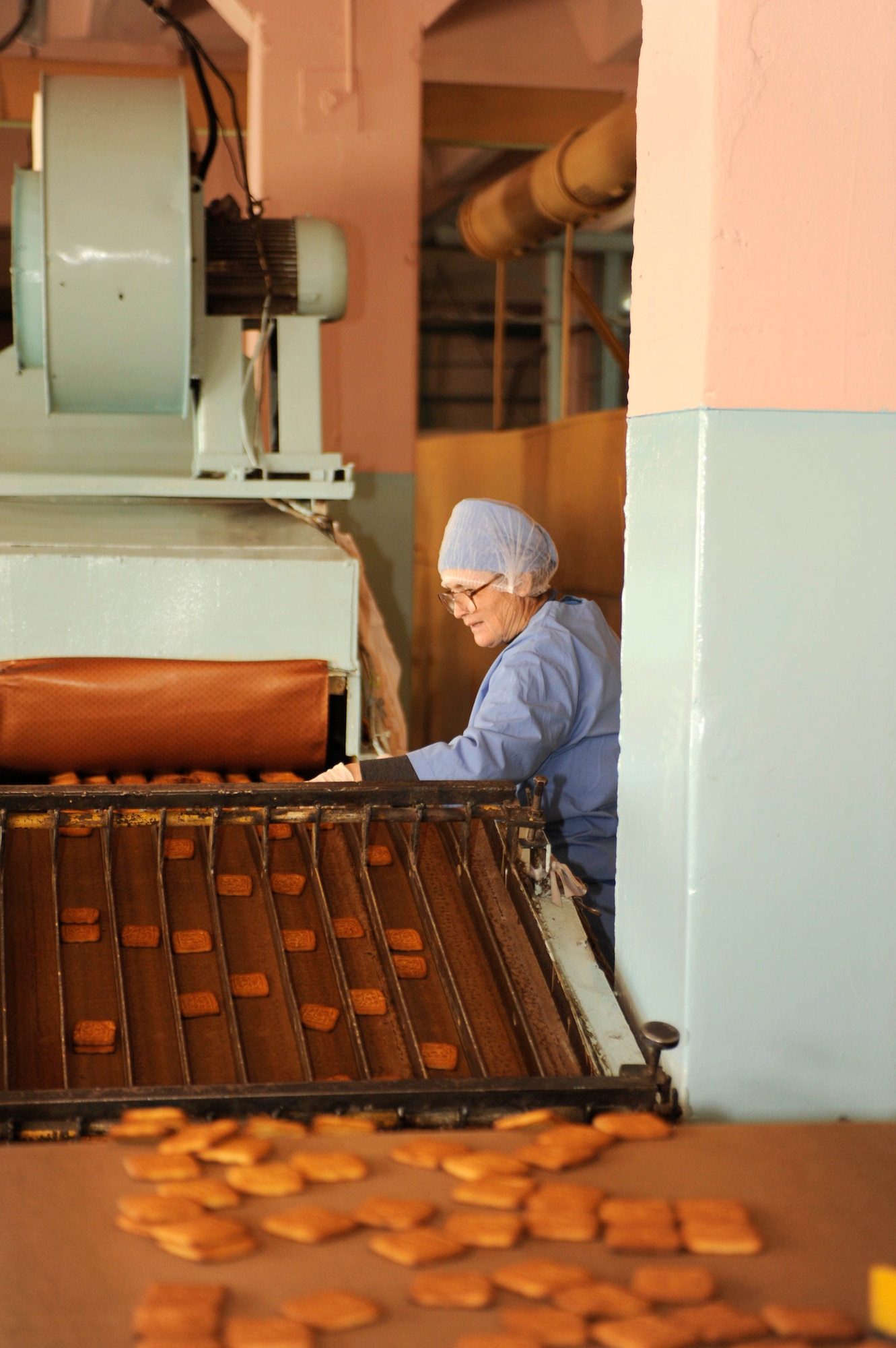 BISHKEK, Kyrgyzstan -- Baked cookies work their way from the oven through the quality control station at the Tattoo Bakery.  Transit Center at Manas officials are looking at expanding the dining facility menu to include locally manufactured goods.  (U.S. Air Force photo/Tech. Sgt. Jerome C. Baysmore) 
