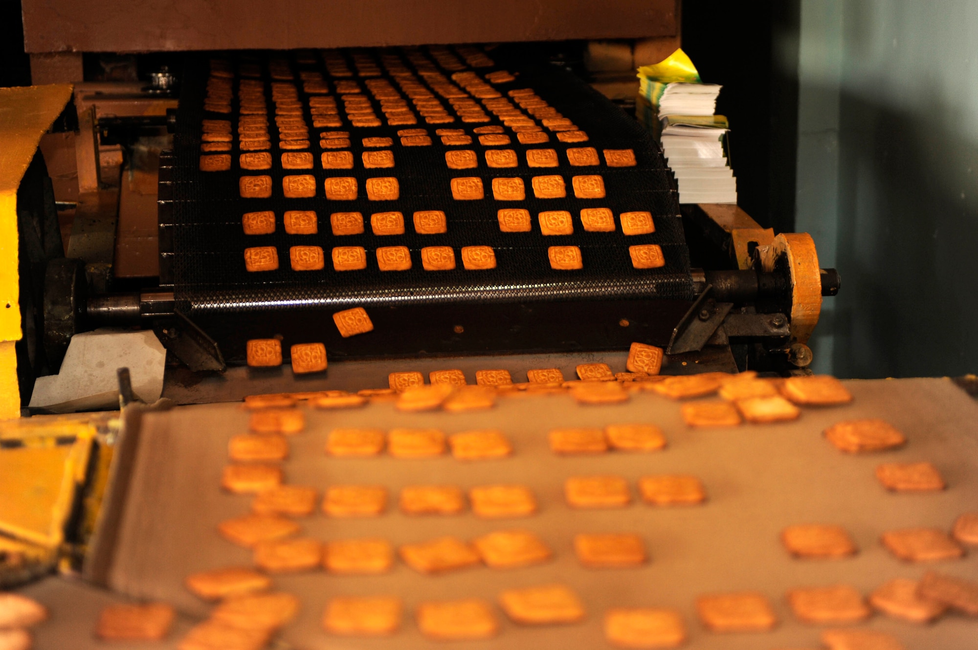 BISHKEK, Kyrgyzstan -- Baked cookies work their way from the oven through the quality control station at the Tattoo Bakery.  Transit Center at Manas officials are looking at expanding the dining facility menu to include locally manufactured goods.  (U.S. Air Force photo/Tech. Sgt. Jerome C. Baysmore) 
