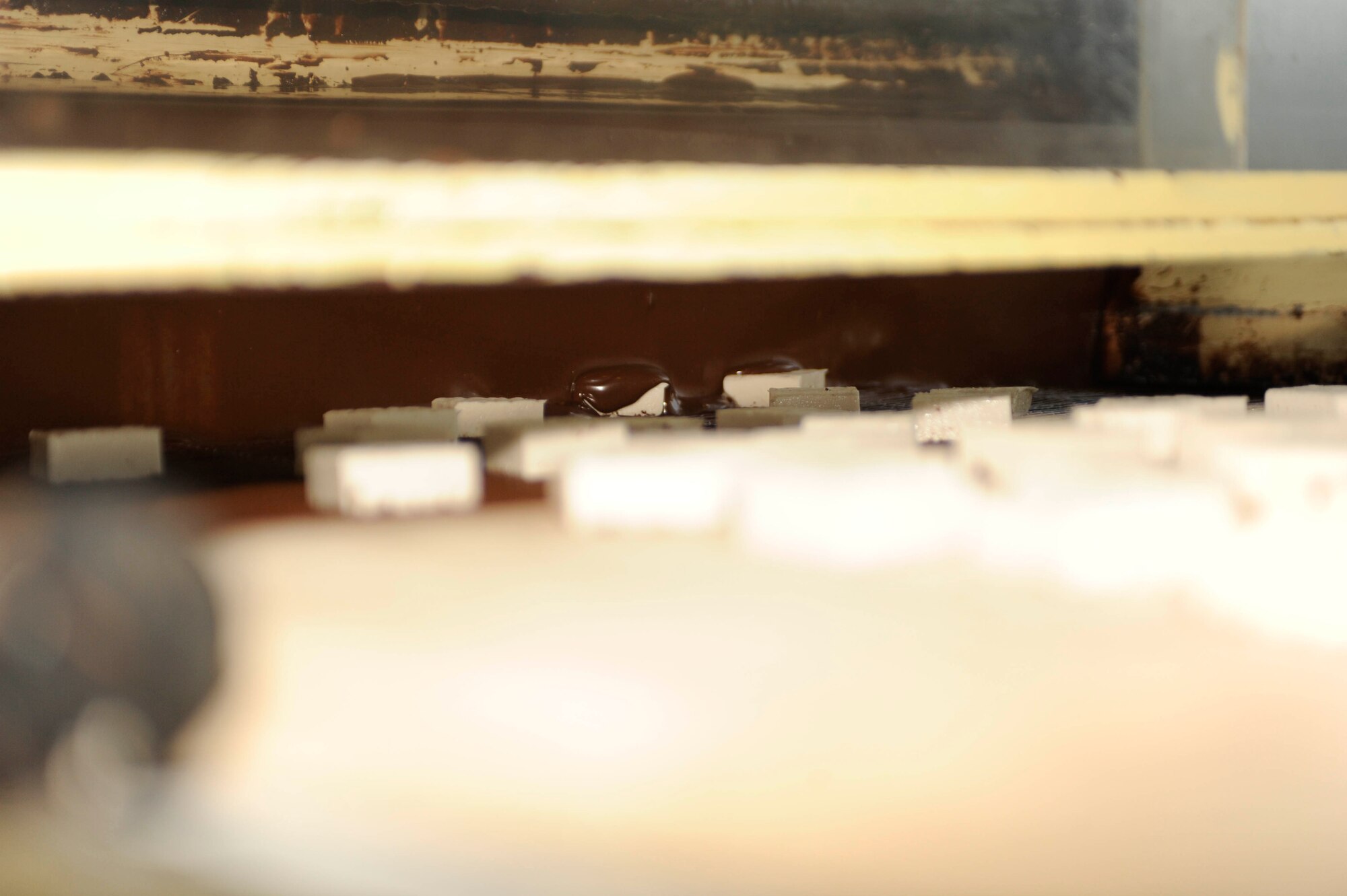 BISHKEK, Kyrgyzstan -- Cookies work their way through the chocolate coating process at the Tattoo Bakery.  Transit Center at Manas officials are looking at expanding the dining facility menu to include locally manufactured goods.  (U.S. Air Force photo/Tech. Sgt. Jerome C. Baysmore) 