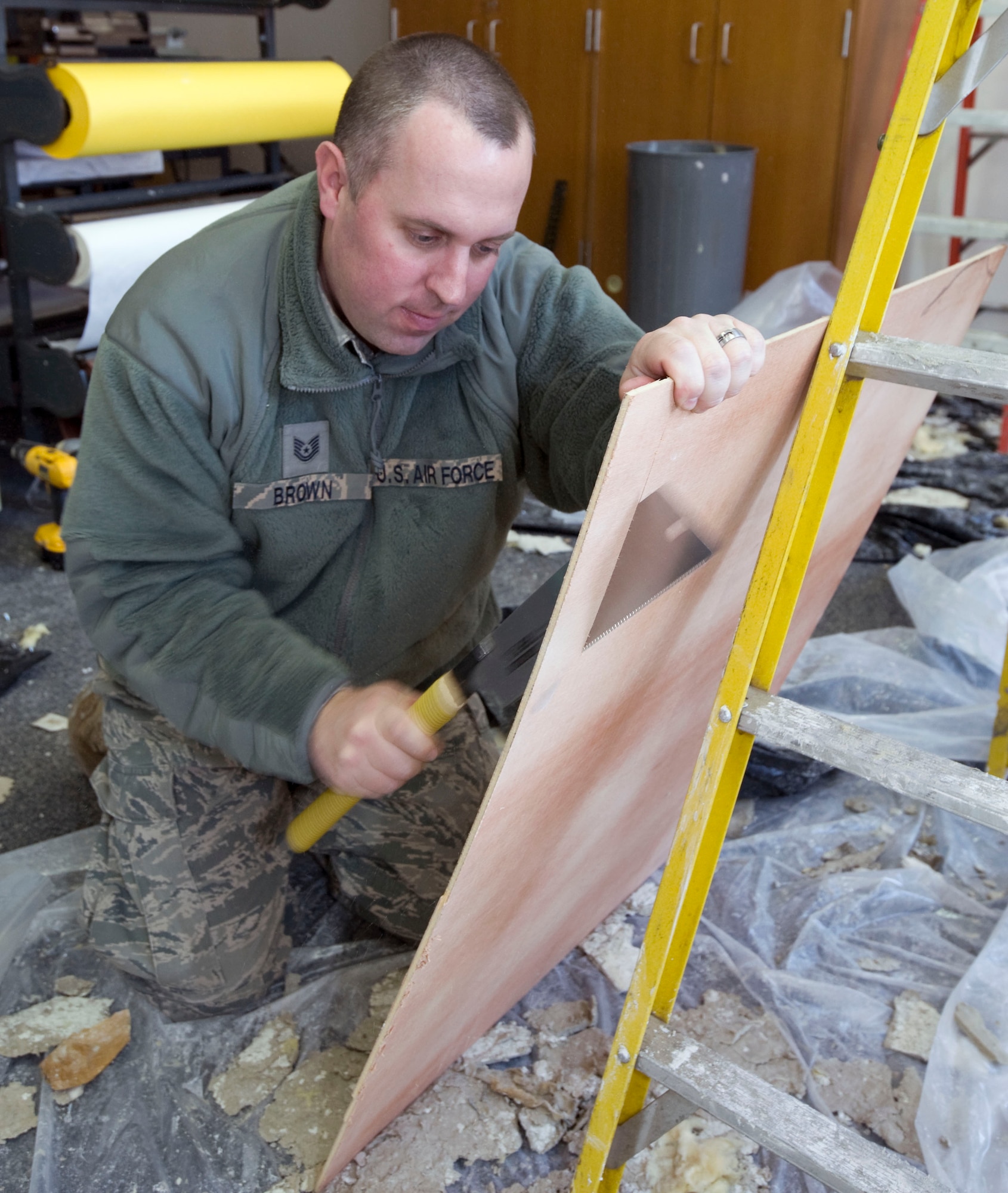 U.S. Air Force Tech. Sgt. Brent Brown of the 35th Civil Engineer Squadron, cuts sheet plywood during repairs at Cummings Elementary School, Misawa Air Base, Japan, Jan. 18, 2011. Sergeant Brown is NCO in charge of Structures, the shop consists of 53 personnel. (U.S. Air Force photo by Tech. Sgt. Russell McBride/Released)