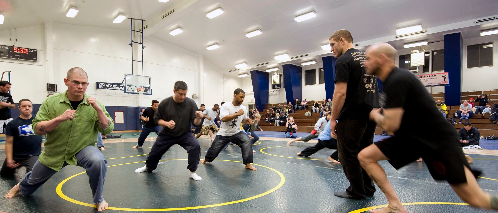 Seminar attendees learn a forward offensive move from Mixed Martial Arts members at Misawa Air Base, Japan, Jan. 15, 2011. The fighters held a grappling training seminar for all ages. (U.S. Air Force photo by Tech. Sgt. Russell McBride/Released)