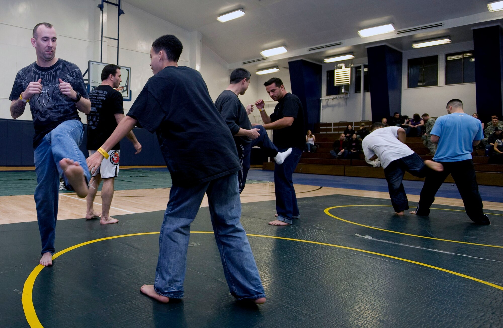 U.S. Army Sergeant First Class Jason McDonald, 708th MI, and son, Noah McDonald, participate in contact drills at Misawa Air Base, Japan, Jan. 15, 2011. Mixed Martial Arts fighters signed autographs afterwards and posed for pictures with their fans. (U.S. Air Force photo by Tech. Sgt. Russell McBride/Released)