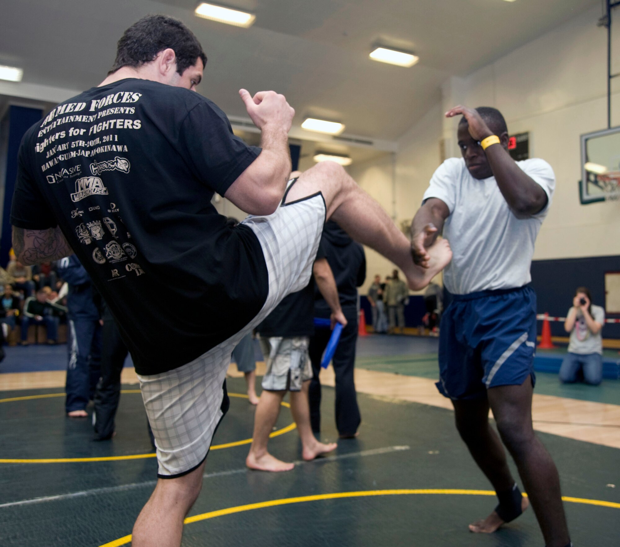 Mixed Martial Arts member Joao Assis, from Brazil demonstrates a kick to a U.S. Air Force Airman at Misawa Air Base, Japan, Jan. 15, 2011. Assis an competitor with the Submission Wrestling Association and also has a black belt with Check-Mat, an international Brazilian Jiu-Jitsu team. (U.S. Air Force photo by Tech. Sgt. Russell McBride/Released)