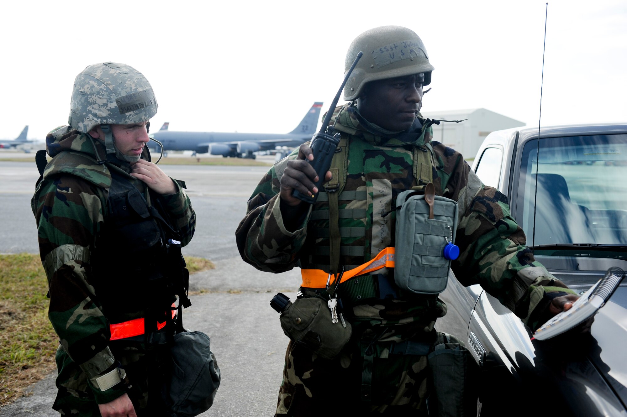 Staff Sgt. Mathew Abner and Staff Sgt. Julien Duncan, both members of the 18th Logistics Readiness Squadron, call in simulated unexploded ordnance on the flightline during Beverly High 11-02, a local operational readiness exercise at Kadena Air Base, Japan, Jan. 19. The LORE is design to train Kadena’s Airmen to survive and operate under various conditions. (U.S. Air Force photo/ Staff Sgt. Jonathan Steffen)