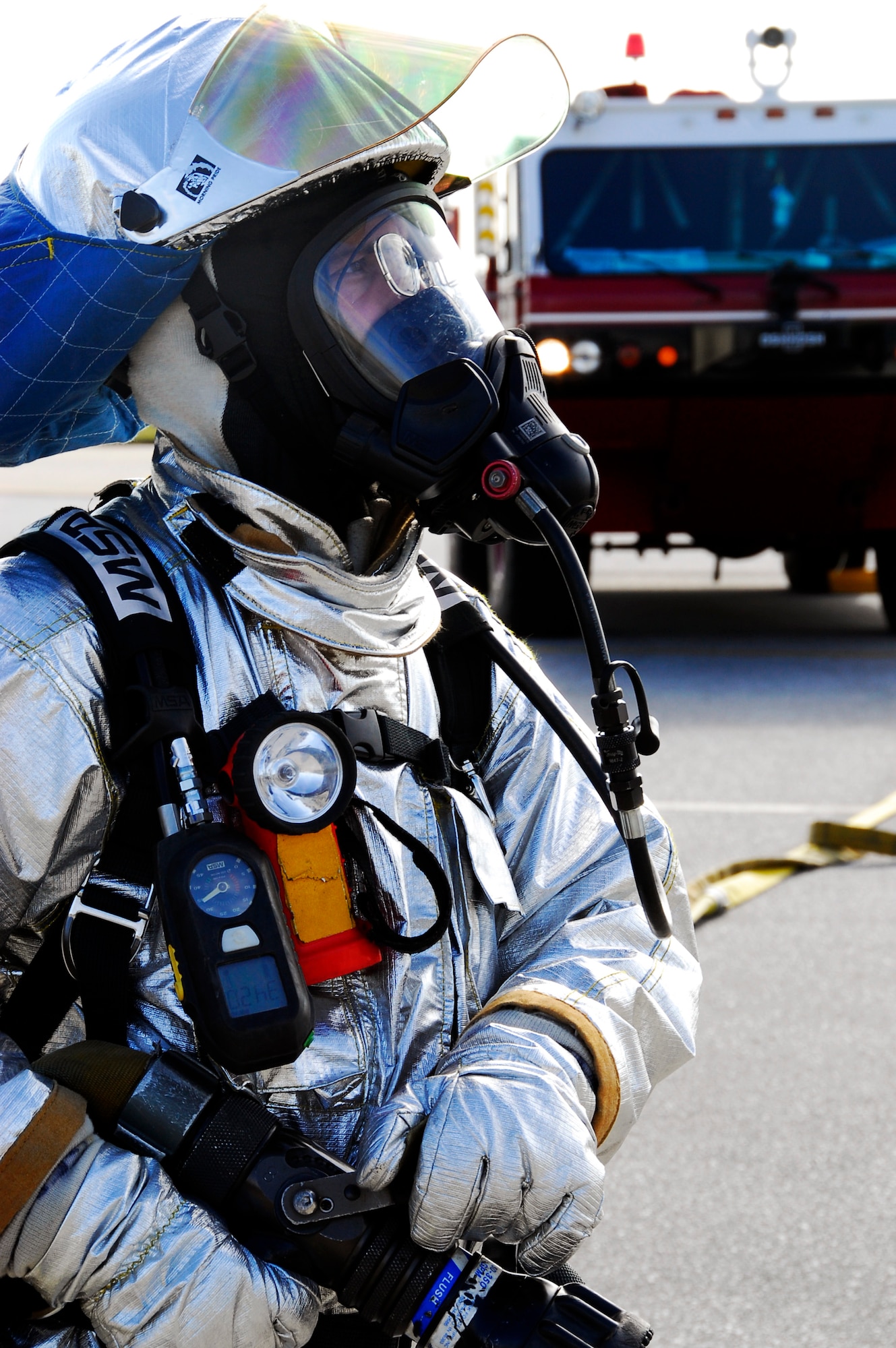 A fireman from Kadena's 18th Civil Engineer Squadron stands ready with a fire hose for a simulated burning aircraft scenario during Beverly High 11-02, a local operational readiness exercise on Kadena Air Base, Japan, Jan. 19. The scenario tested the skills and capabilities of Kadena's emergency response personnel. (U.S. Air Force photo/ Airman 1st Class Maeson L. Elleman)