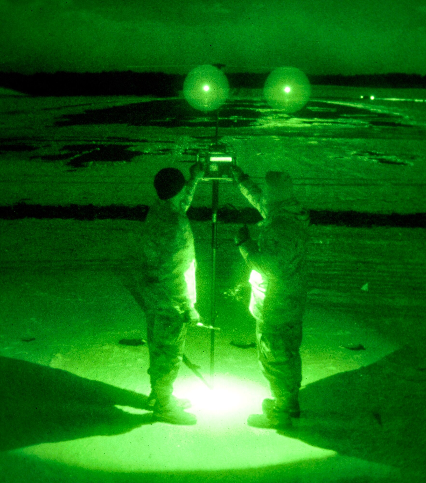 U.S. Air Force Senior Airmen Kai Hall, left, and Cavin Meneses, 35th Communications Squadron airfield systems technicians, use a portable instrument landing system to verify that the system is transmitting the correct location for the center of the runway Jan. 20, 2011, Misawa Air Base, Japan.  If the ILS malfunctions, aircraft could be directed to land off the runway, damaging the aircraft. (U.S. Air Force photo by Tech. Sgt. Phillip Butterfield/Released)