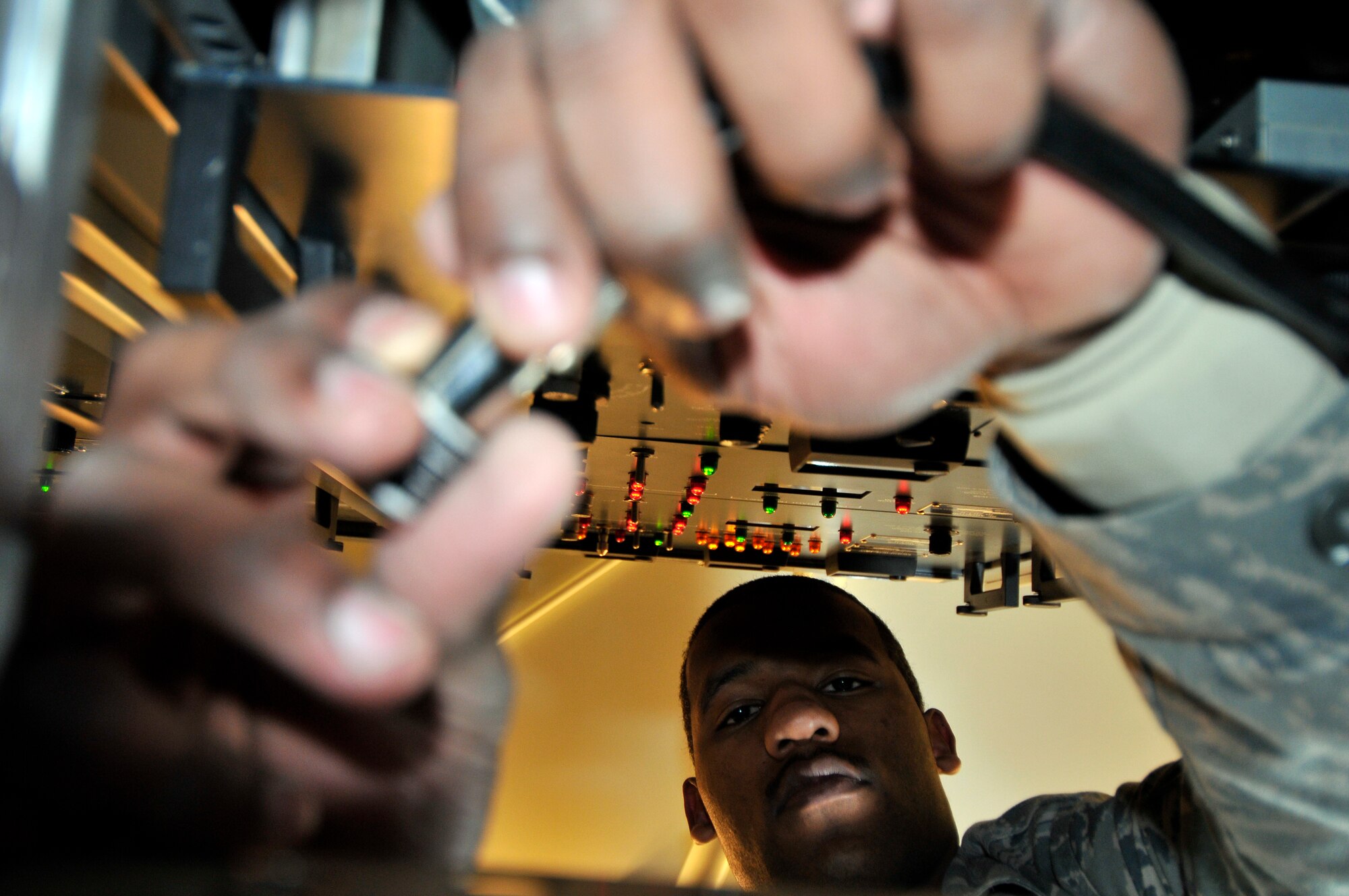 U.S. Air Force Senior Airman Kai Hall, 35th Communications Squadron airfield systems technician, connects a test cable to the instrument landing system during an operational check Jan. 20, 2011, Misawa Air Base, Japan. The operational check uses different cables and dummy loads to simulate actual operation of the system. (U.S. Air Force photo by Tech. Sgt. Phillip Butterfield/Released)