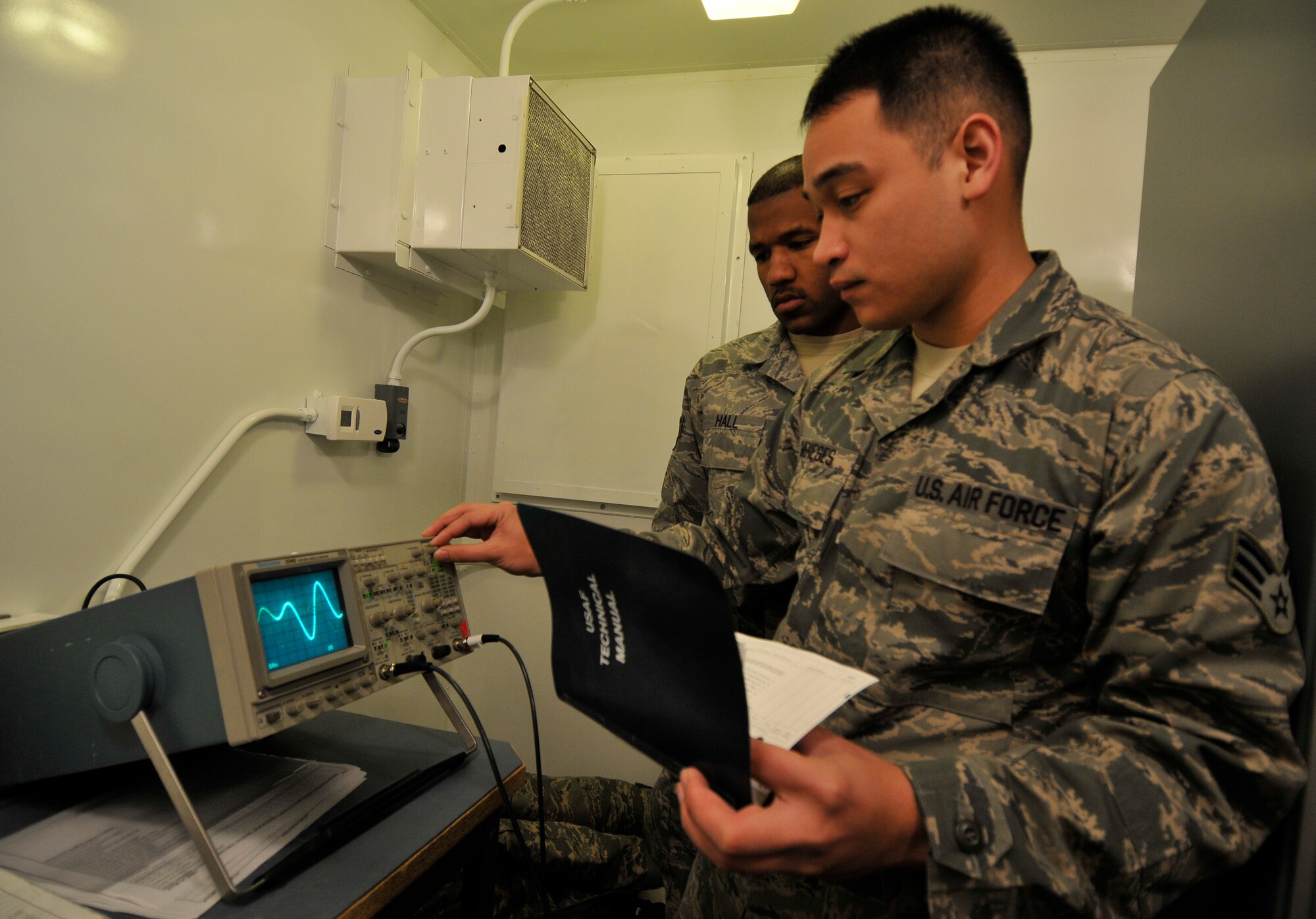 U.S. Air Force Senior Airmen Cavin Meneses, front, and Kai Hall, 35th Communications Squadron airfield systems technicians, check the waveform of the instrument landing system signal on an oscilloscope during a system performance check Jan. 20, 2011, Misawa Air Base, Japan. Pilots use data from the ILS to align their approach with the runway for a safe and accurate landing. (U.S. Air Force photo by Tech. Sgt. Phillip Butterfield/Released)
