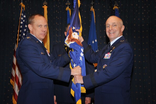 General Donald Hoffman, Air Force Materiel Command commander, passes the Air Force Nuclear Weapons Center guidon to Brig. Gen. Garrett Harencak during a ceremony Jan. 20 at the Mountain View Club.  U.S. Air Force Photo by Todd Berenger.