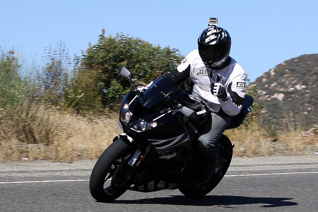 A Marine with the Marine Corps Base Camp Pendleton, Headquarters & Support Battalion’s motorcycle club flashes a thumbs-up as he zips through a curve on the H&S Bn. motorcycle club group ride to Long Beach, CA., Jul. 20. The group ride was more than 150 miles, and included Primary Military Education at the World War II Submarine Memorial in Seal Beach, CA.