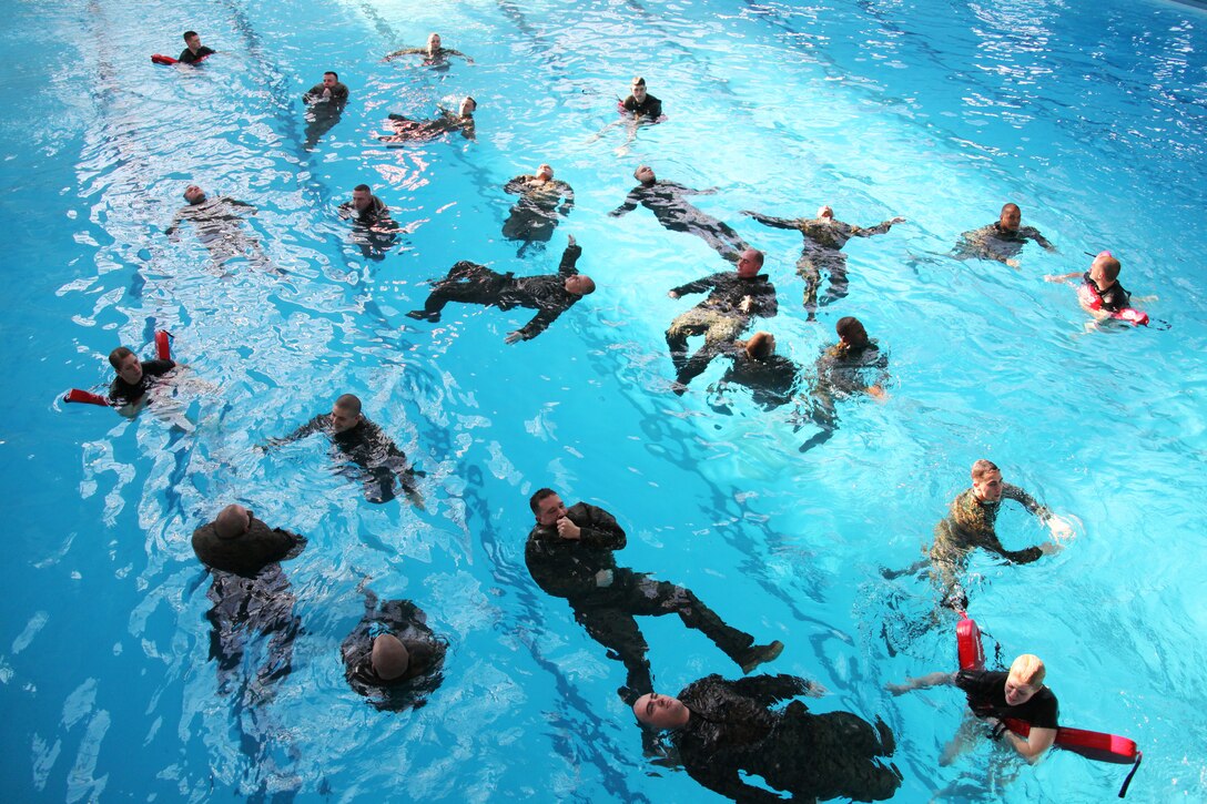 Marines with the 22nd Marine Expeditionary Unit Command Element tread water during water survival training aboard Camp Johnson, N.C., Jan. 20, 2011.  This water survival test is the first time the command element conducted the new water survival qualification course. The 22nd MEU is a multi-mission capable force of 2,200 Marines and sailors and comprised of Aviation Combat Element, Marine Medium Tilt Rotor Squadron 263 (Reinforced); Logistics Combat Element, Combat Logistics Battalion 22; Ground Combat Element, Battalion Landing Team, 2nd Battalion, 2nd Marine Regiment; and its command element.