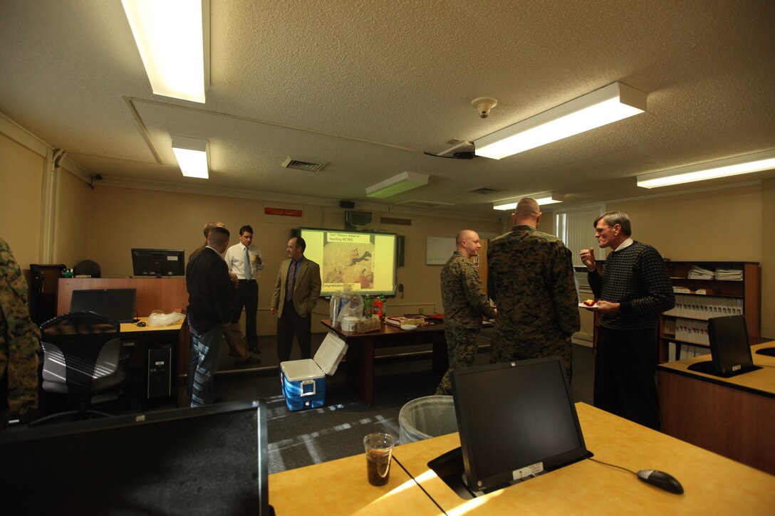 MARINE CORPS BASE CAMP JOHNSON, N.C. – Friends gather around to celebrate the room dedication for Carl B. Wilson, a retired gunnery sergeant who spent 20 years in the military, served two tours as a drill instructor and worked at the Drill Instructor School before retiring. He was later hired as a senior consultant for a web-based application that supports training the Train the Trainer School aboard Camp Johnson, Jan 21. Wilson has dedicated his life to supporting the Marine Corps’ mission both as a service member and now as a civilian.