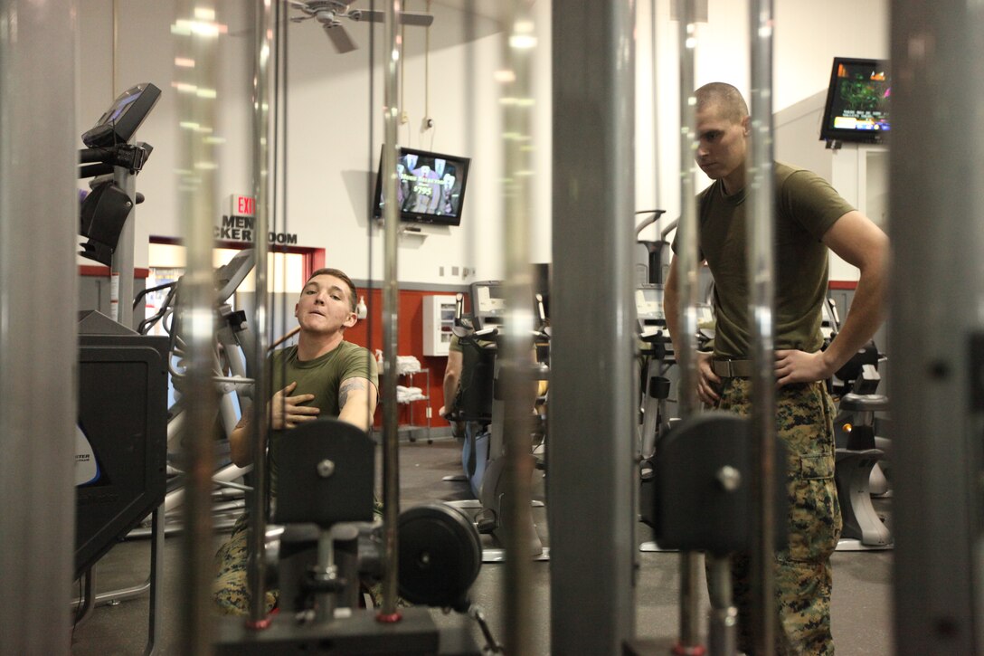 Lance Cpl. Mark Gassaway, (left), and Lance Cpl. Tyler Lyons (right), both with 5th Battalion, 10th Marine Regiment, 2nd Marine Division, make use of exercise equipment at the Area 2 gymnasium, recently. Gassaway and Lyons, normally patrons of the French Creek Fitness Center, are using the gym’s equipment for the time being, but plan to make a return to French Creek upon completion of the heating, air conditioning and ventilation system in April this year.