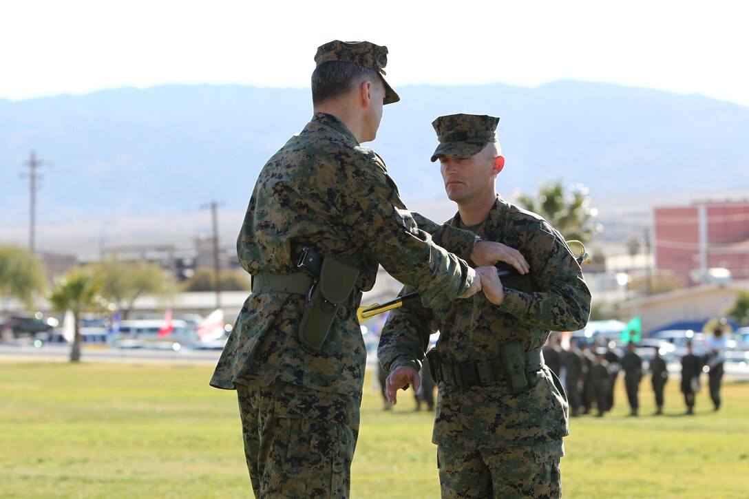 Sergeant Maj. Michael A. Miller receives the noncommissioned officer’s sword from the commanding officer during the Marine Unmanned Aerial Vehicle Squadron 1 relief and appointment ceremony Jan. 21, 2011, at Lance Cpl. Torrey L. Gray Field.
