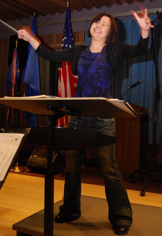 Chie Imaizumi conducts the third movement of "Opening New Doors" during a rehearsal with the Air Force Academy Band in their recording studio at Peterson Air Force Base, Colo., Jan. 21, 2010. The three movements represent recalling previous memories, overcoming adversity and enjoying new opportunities. Ms. Imaizumi is a native of Saitama, Japan, and currently lives in Los Angeles. (U.S. Air Force photo/Staff Sgt. Don Branum)