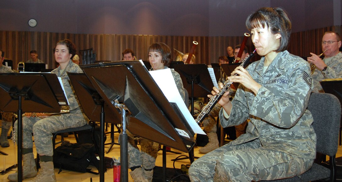 Tech. Sgt. Monica Ding (right, foreground) and other Air Force Academy Band performers rehearse "Opening New Doors," by Chie Imaizumi, in their recording studio at Peterson Air Force Base, Colo., Jan. 21, 2011. The piece comprises three measures, which represent memories of fond times, a struggle to overcome adversity and realization of new opportunities. Sergeant Ding, a native of Mount Prospect, Ill., is an oboist with the Academy Band's concert and marching bands and Rampart Winds ensemble. (U.S. Air Force photo/Staff Sgt. Don Branum)