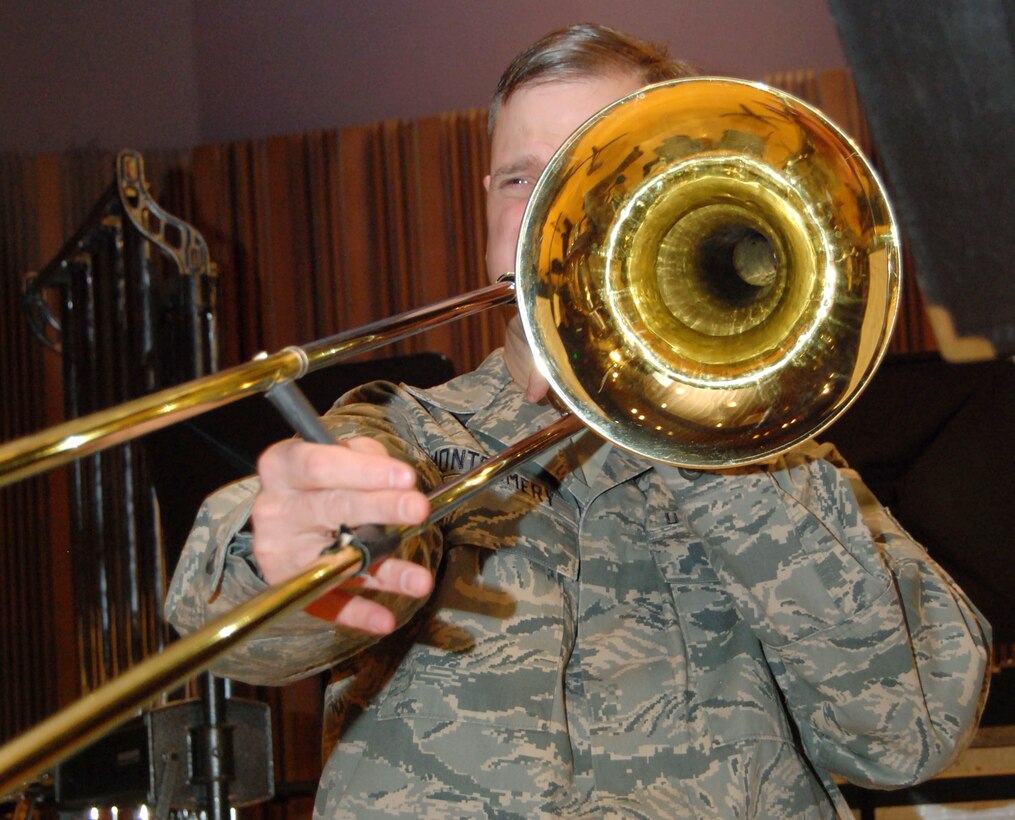 Master Sgt. Gene Montgomery performs on bass trombone during a rehearsal of "Opening New Doors" at Peterson Air Force Base, Colo., Jan. 21, 2011. Sergeant Montgomery, a native of Henderson, Ky., performs with the Air Force Academy Band's concert and marching bands and the Falconaires ensemble. (U.S. Air Force photo/Staff Sgt. Don Branum)