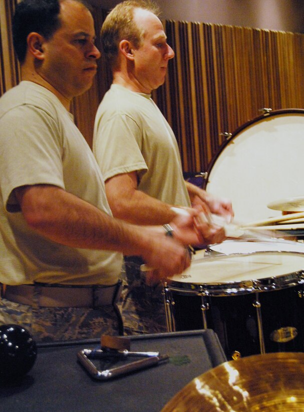 Tech. Sgt. Henrique de Alameda, left, and Master Sgt. Steven Przyzycki perform on drums during a rehearsal of "Opening New Doors," composed by Chie Imaizumi, in the Air Force Academy Band's studio at Peterson Air Force Base, Colo., Jan. 21, 2010. Sergeants de Alameda and Przyzycki are percussionists with the marching and concert bands. Sergeant de Alameda, a native of Recife, Brazil, also perfoms with the Falconaires, and Sergeant Przyzycki, a Chicago native, also performs with the Air LIFT ensemble. (U.S. Air Force photo/Staff Sgt. Don Branum)