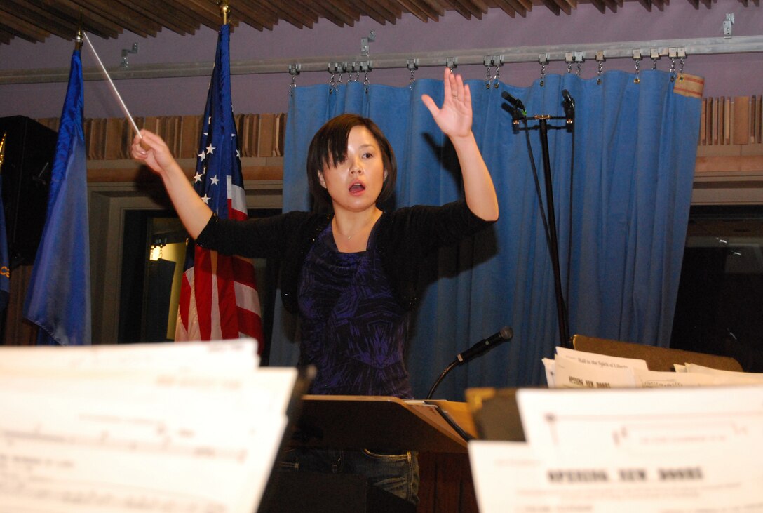 Chie Imaizumi conducts an Air Force Academy Band rehearsal of "Opening New Doors" in the Academy Band's recording studio at Peterson Air Force Base, Colo., Jan. 21, 2011. Ms. Imaizumi is a native of Saitama, Japan, and a graduate of the Berklee College of Music in Boston. (U.S. Air Force photo/Staff Sgt. Don Branum)