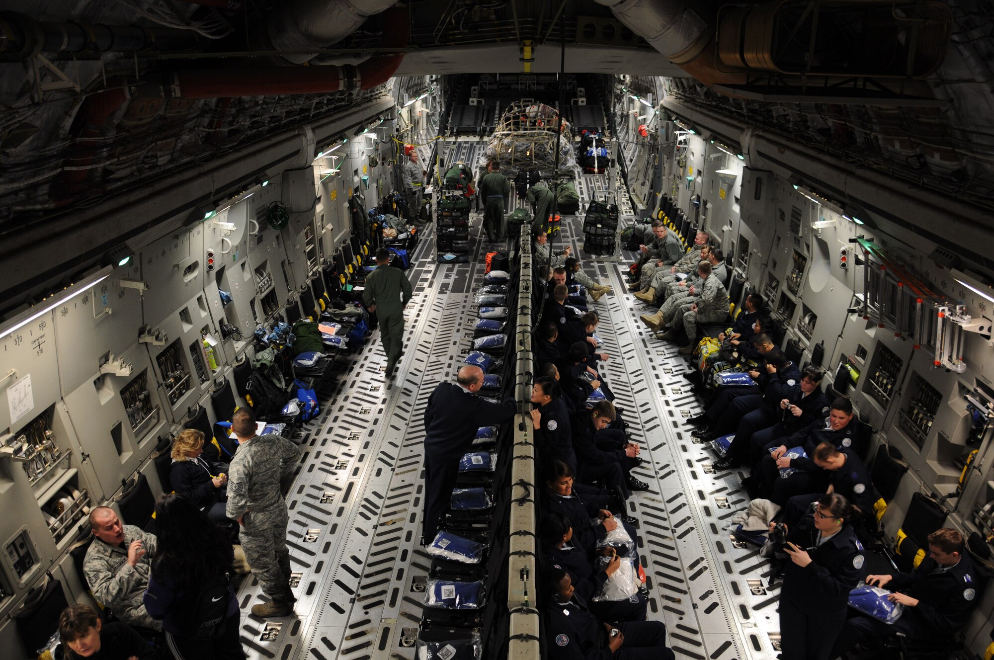 MCCHORD FIELD, Wash.- 446th Airlift Wing aircrew members carry out their duties by ensuring cargo, passengers, and other crewmembers are secure on a C-17 Globemaster III before taking off on a training mission to Joint Base Pearl Harbor-Hickam, Hawaii, Jan. 10. Reservists in the 446th Operations Group are always training to stay current on their qualifications and be ready to deploy at a moment's notice. (U.S. Air force photo/Master Sgt. Jake Chappelle)