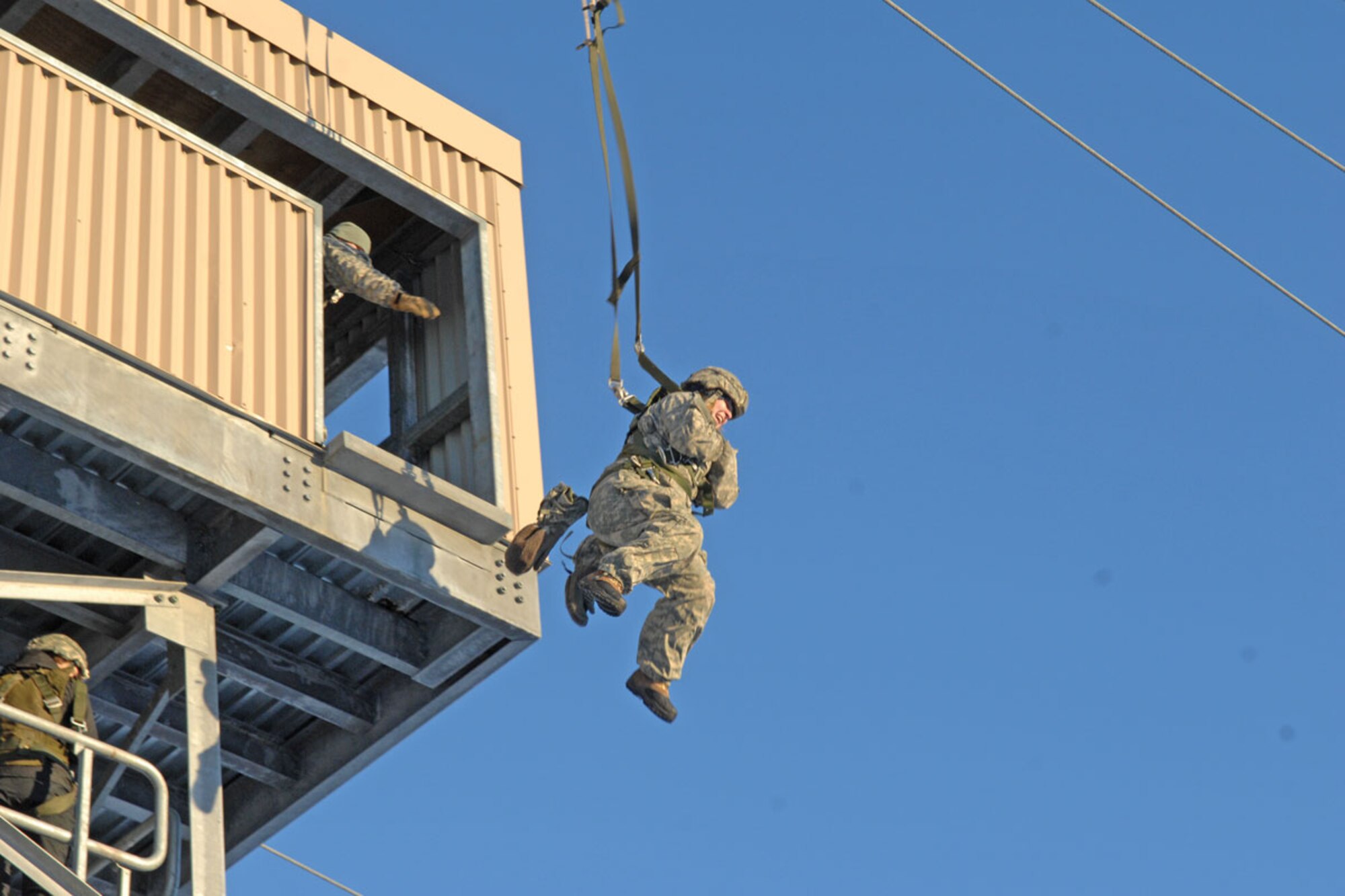 The wife of a 3-509th Soldier exits the 34-foot mock jump tower. The 34-foot towers are designed to mimic the interior of actual military aircraft and further assists in the training of paratroopers’ skills. (U.S. Army photos/Staff Sgt. Matthew E. Winstead)