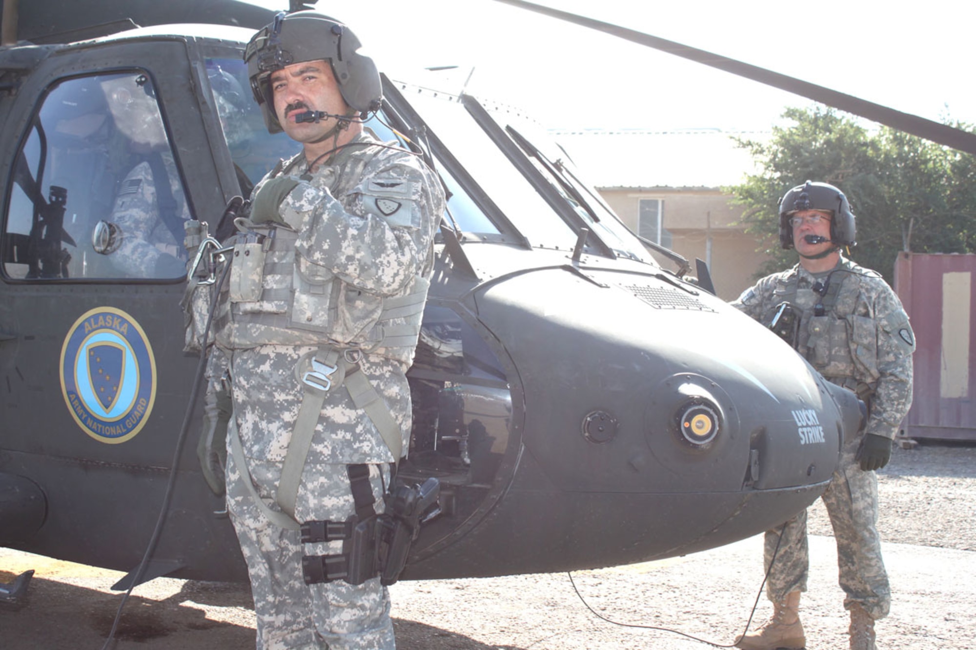 Sgt. Donald Chapman, left, of Juneau, and Staff Sgt. Stephen Elliott Jr., Alaska Army National Guardsmen from Palmer, stand near a UH-60 Black Hawk helicopter before a mission. (Courtesy photo)