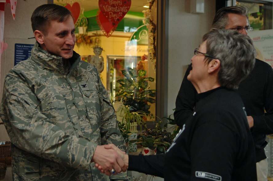 Col. Jeffrey Taliaferro, 28th Bomb Wing commander, congratulates Linda Converse, wife of retired Air Force Lt. Col. Larry Converse, on winning a new, customized Ford Mustang at Ellsworth Air Force Base, S.D., Jan. 20, 2011. The Mustang was awarded as the grand prize of a worldwide contest sponsored by the Army and Air Force Exchange Service and the Monster Beverage Company. (U.S. Air Force photo/Senior Airman Jarad A. Denton)