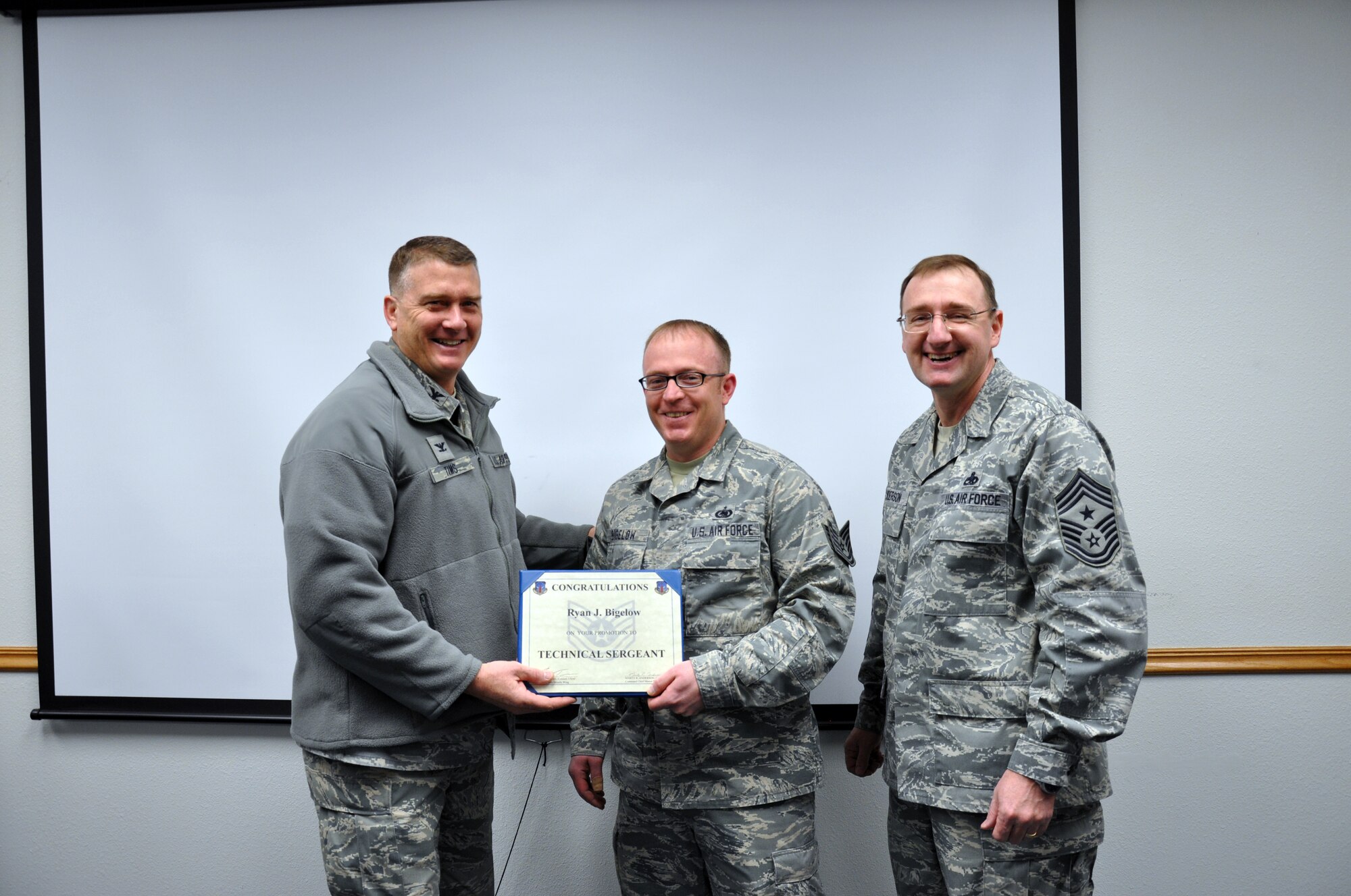 Colonel Greg Tims, 90th Missile Wing commander and CMSgt Marty Anderson, 90th MW command chief, made a surprise visit to promote Tech. (sel.) Sgt. Ryan Bigelow, 90th Logistics Readiness Squadron Jan. 13 as part of the stripes for exceptional performance recognition program. The promotion came directly from Air Force Global Strike Command in recognition of the Airman's outstanding performance on the job.