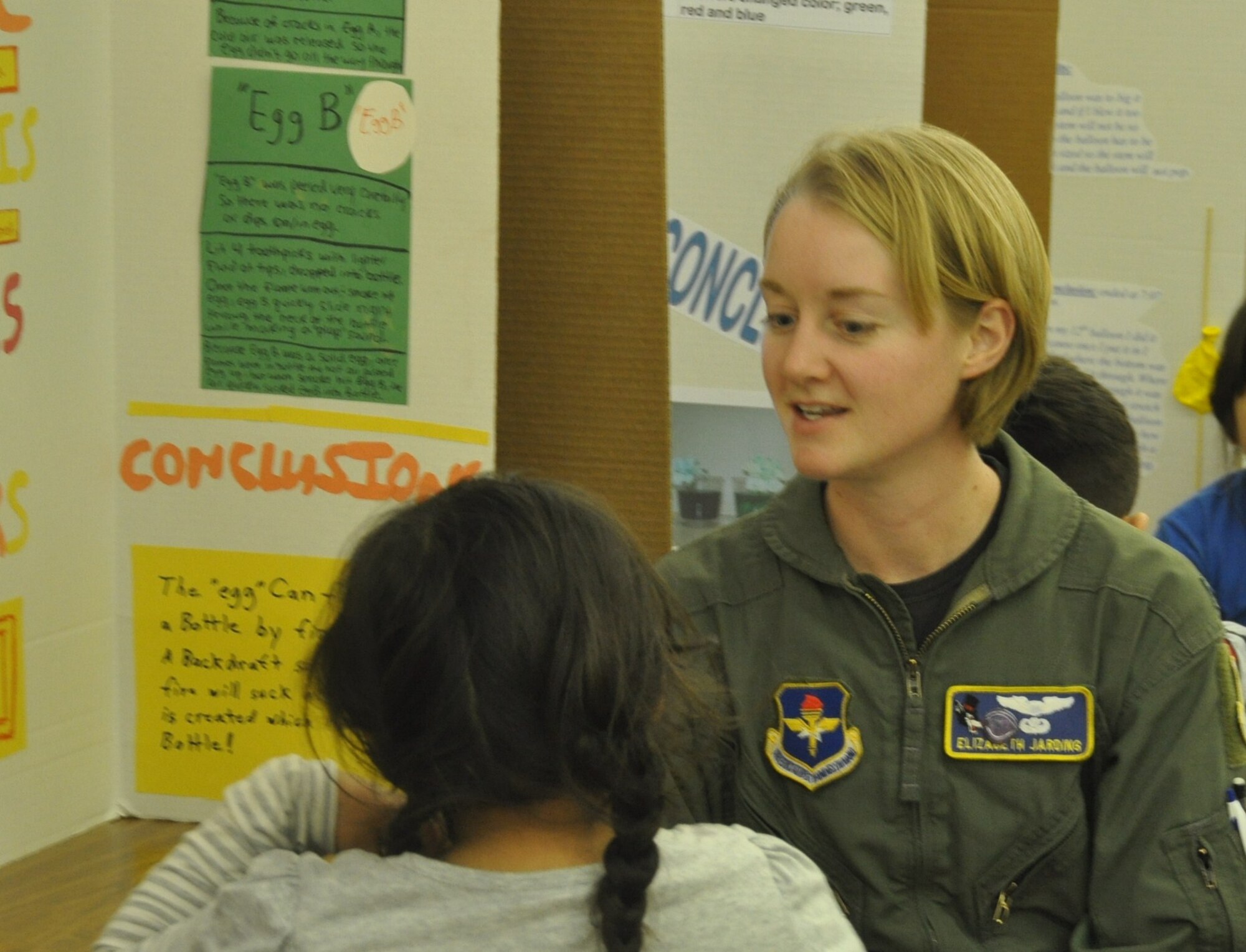 LAUGHLIN AIR FORCE BASE, Texas –First Lt. Elizabeth Jarding, 86th Flying Training Squadron, judges a Lamar Elementary student’s science fair project in Del Rio Jan. 19. Winners from science fairs such as this one will compete at the San Felipe Del Rio Consolidated Independent School District science fair Feb. 3 at the Del Rio Civic Center. (U.S. Air Force photo by 2nd Lt. Ashley Wolfe)