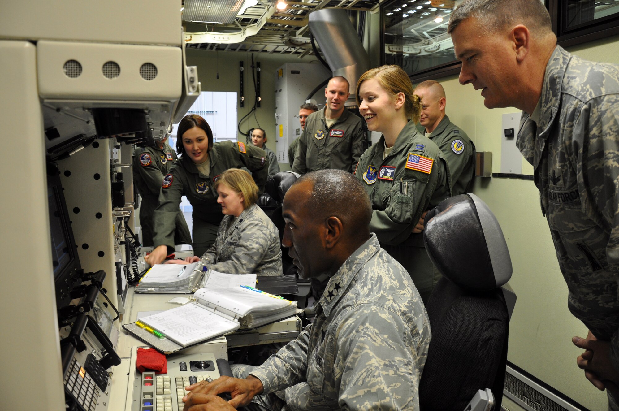 Colonel Greg Tims, 90th Missile Wing Commander looks on as Major General A.J. Stewart, AFPC Commander, ‘key turns’ as the ‘missile crew commander’ during a mock missile alert procedure in a training simulator with the 90th Operations Support Squadron on Jan 13. The general’s visit was part of AFPC’s “Spread the Word” briefing highlighting nuclear assignments. (U.S. Air Force photo by 1st Lt. Brooke Brzozowske)