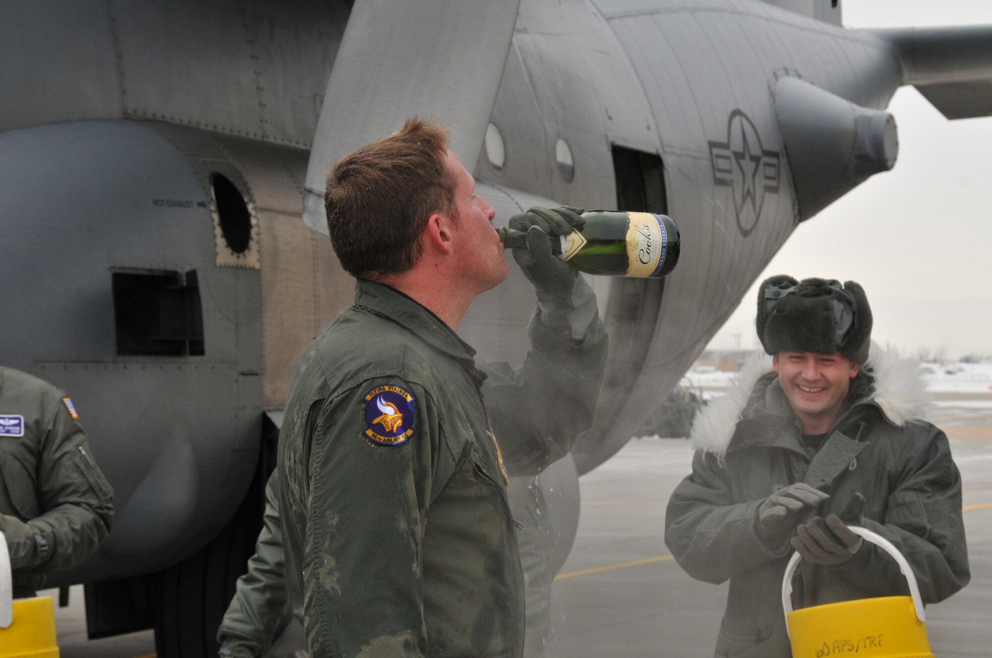 Chief Master Sgt. Mark Hartnett, 96th Airlift Squadron flight engineer, is splashed down in sub zero temperatures after his final flight. Chief Harnett is retiring after 33 years of Service.  (Air Force Photo/Tech. Sgt. Bob Sommer)