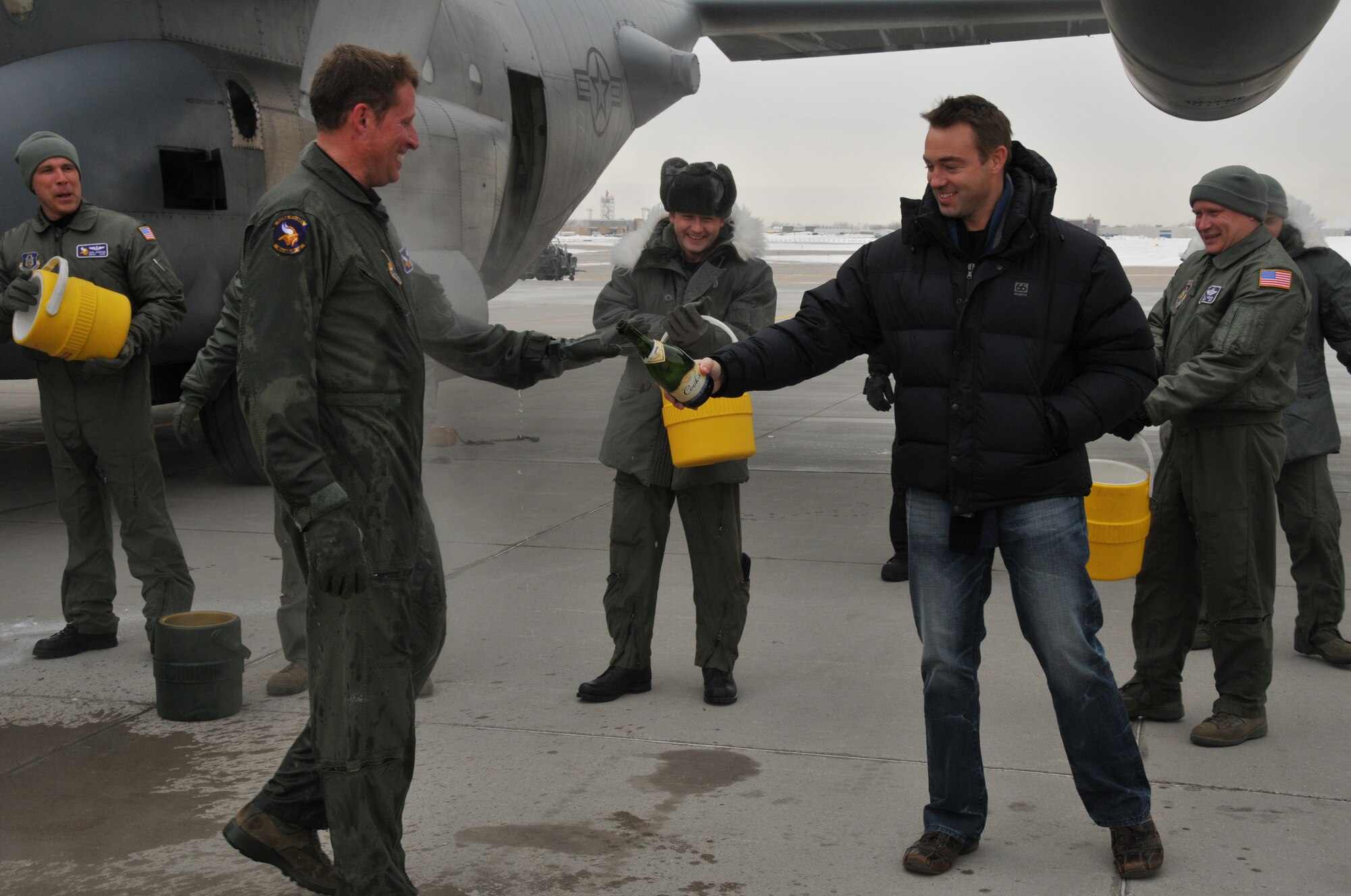 Chief Master Sgt. Mark Hartnett, 96th Airlift Squadron flight engineer, is splashed down in sub zero temperatures after his final flight. Chief Harnett is retiring after 33 years of Service.  (Air Force Photo/Tech. Sgt. Bob Sommer)